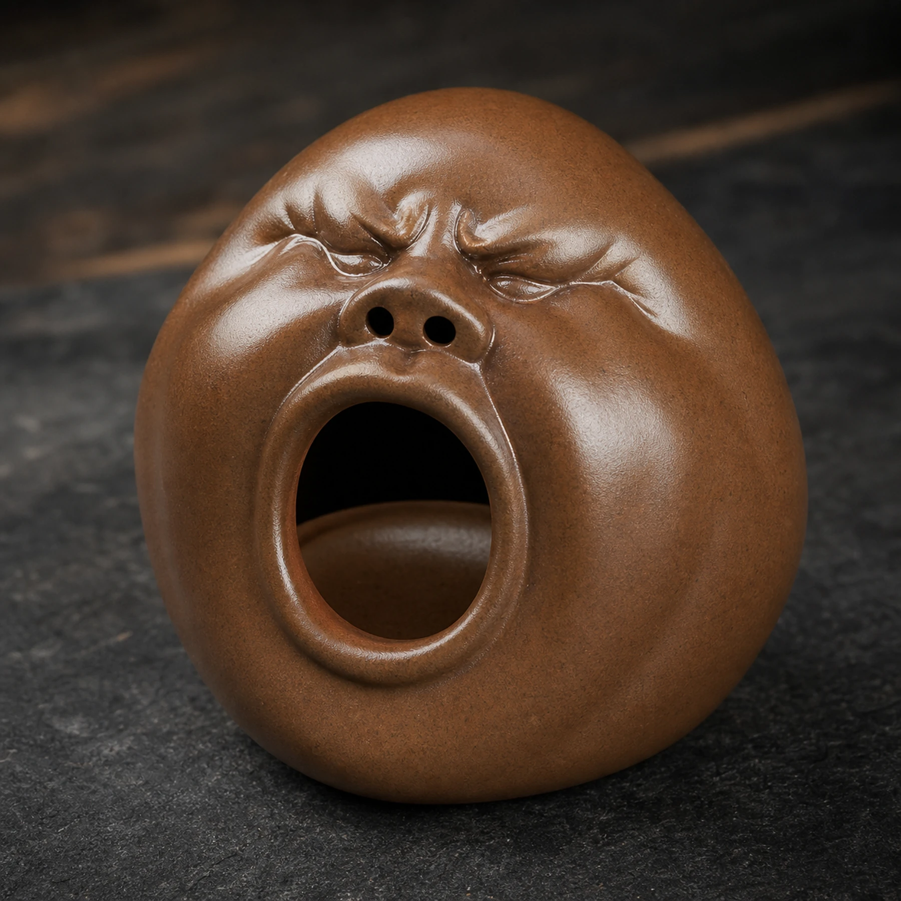 Brown expressive face incense holder sculpted detail