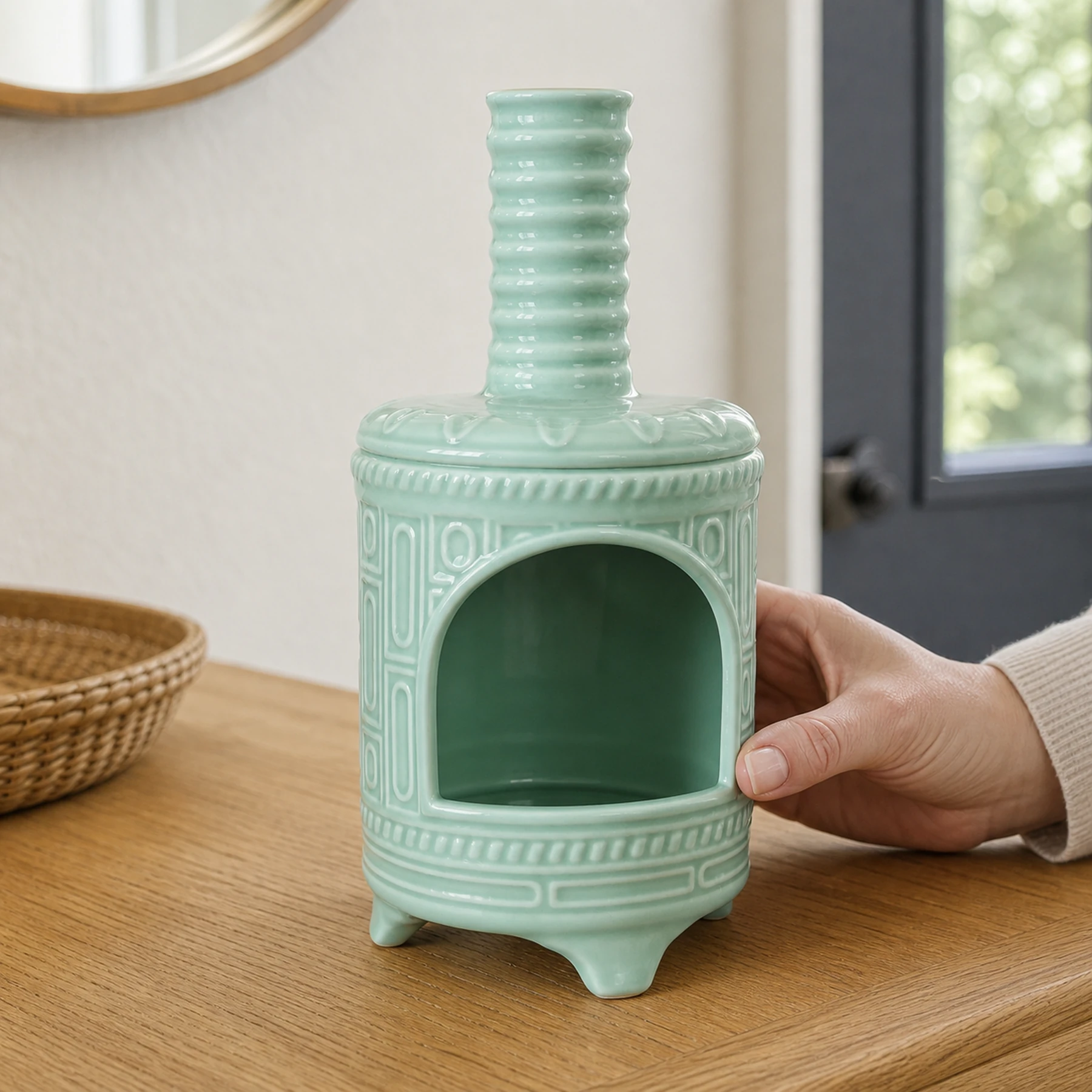 Light Green ceramic incense burner shown with an adult hand for tabletop scale