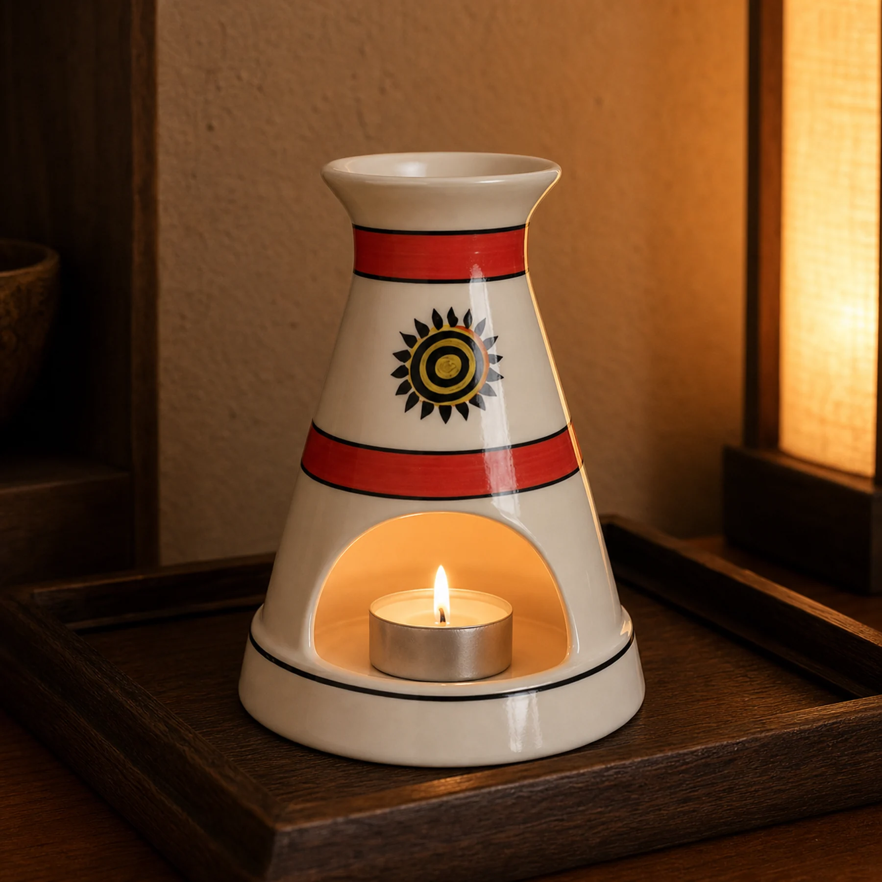 White ceramic sun motif Palo Santo holder used with a tealight candle