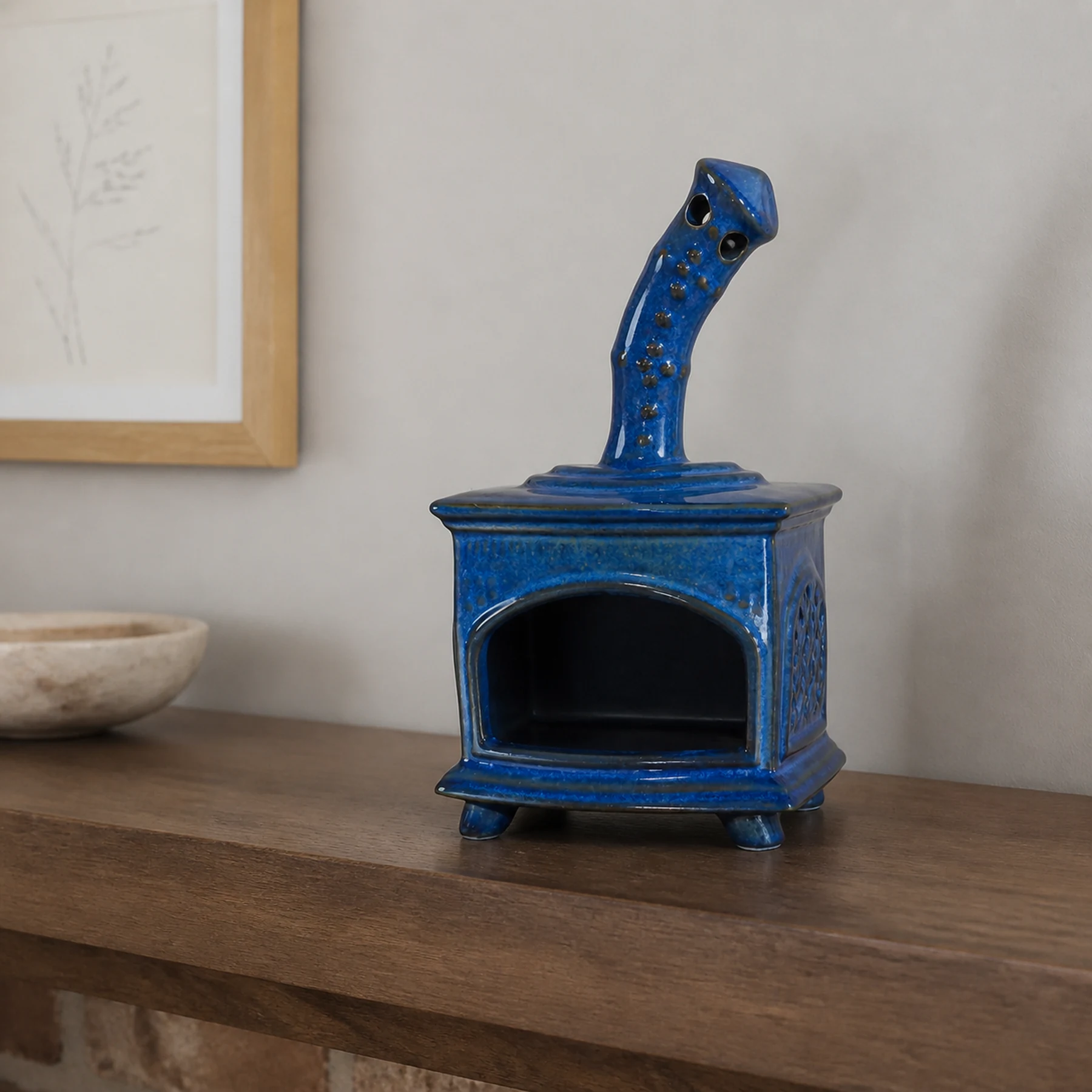 Blue ceramic fireplace incense holder styled on a home mantel shelf