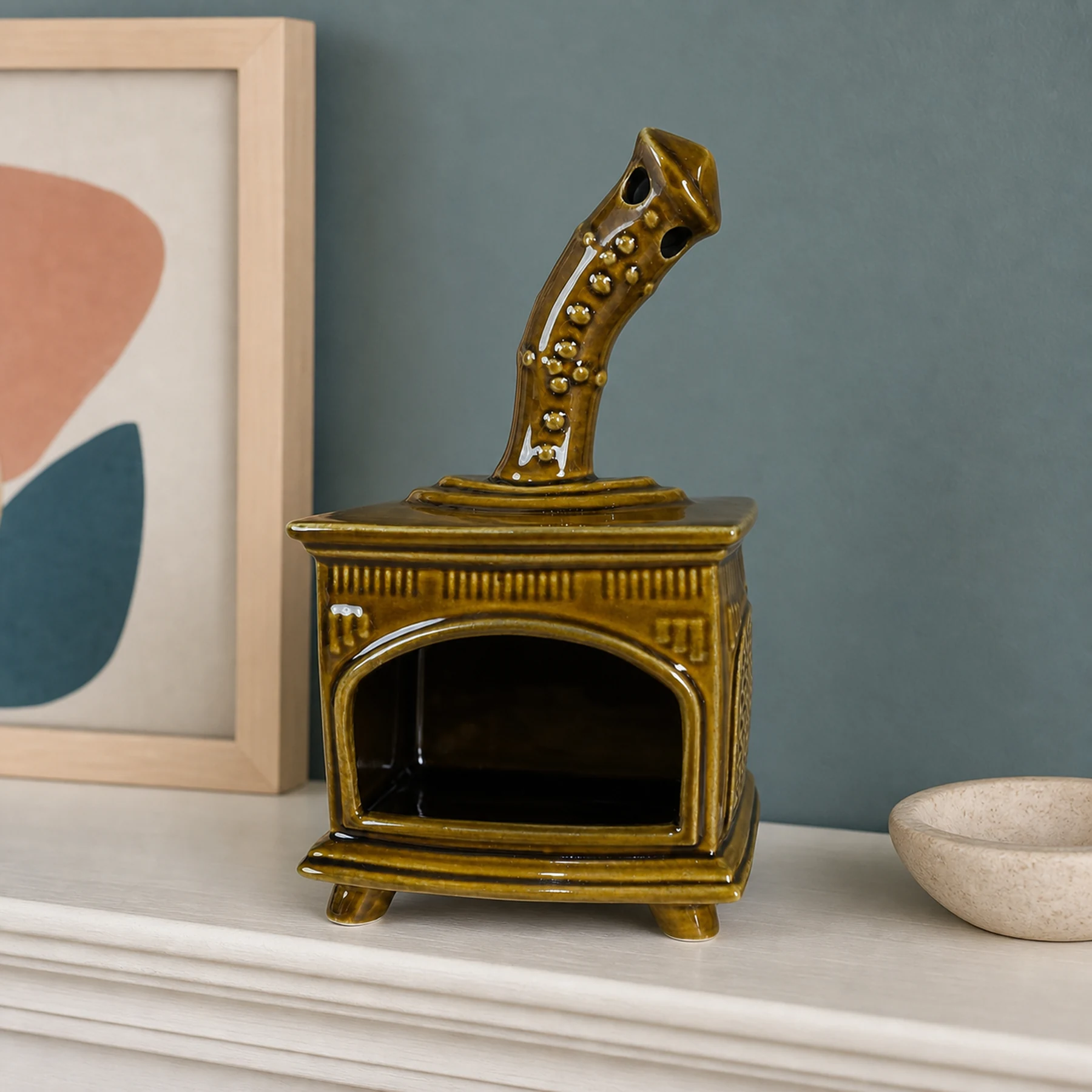 Brown ceramic fireplace incense holder styled on a home mantel shelf