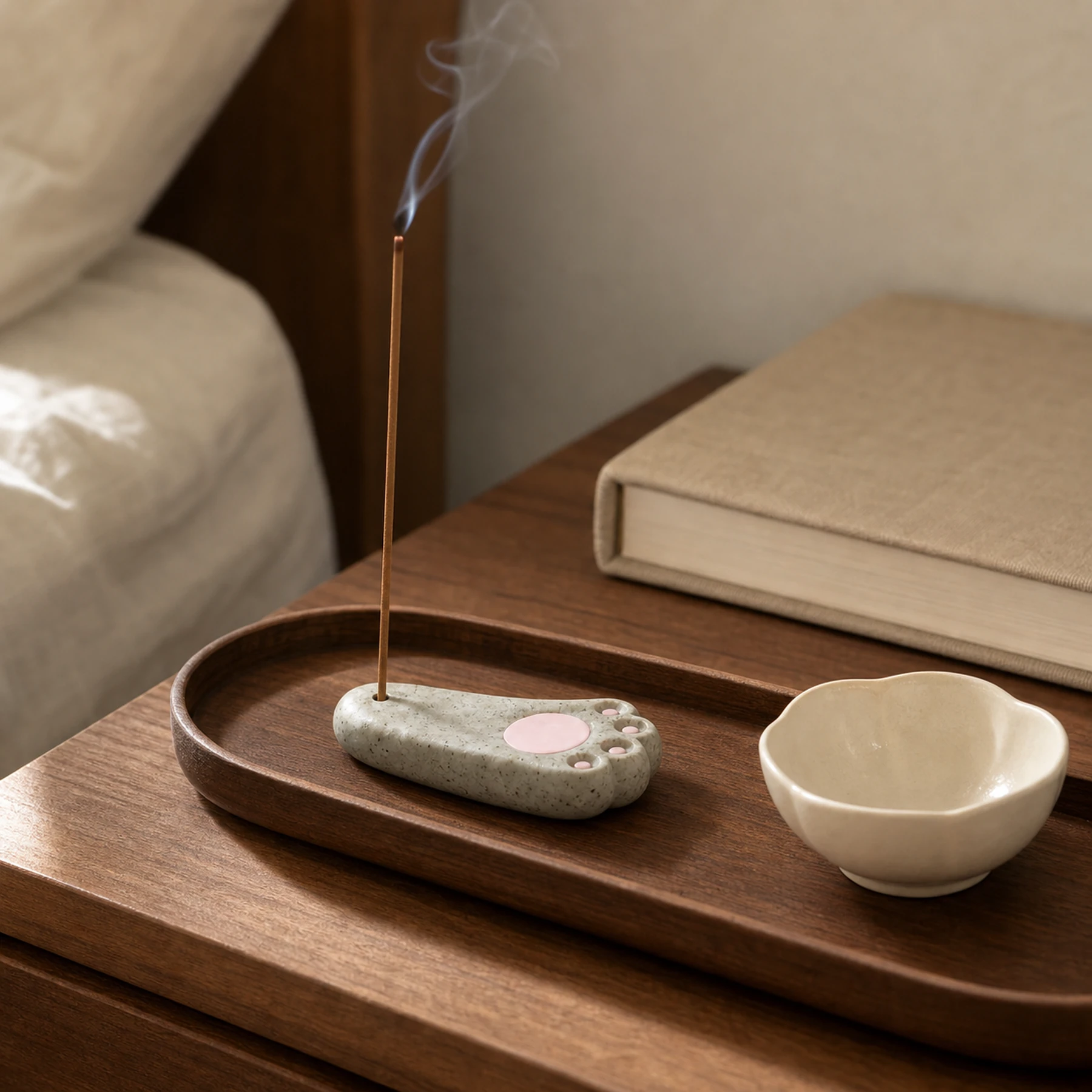 Speckled gray cat paw stick incense holder in a realistic home setting