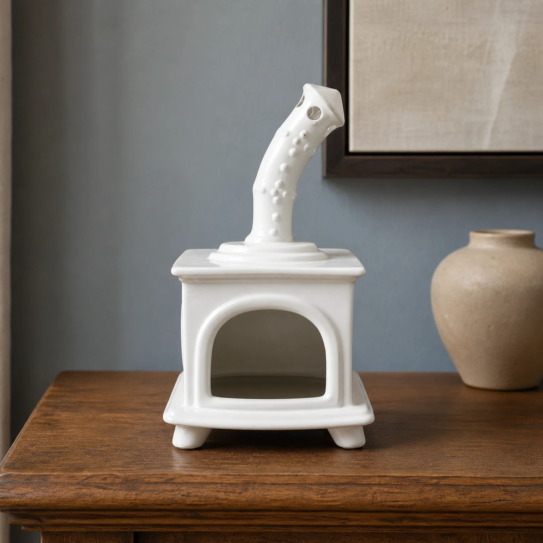 White ceramic fireplace incense holder styled on a home mantel shelf