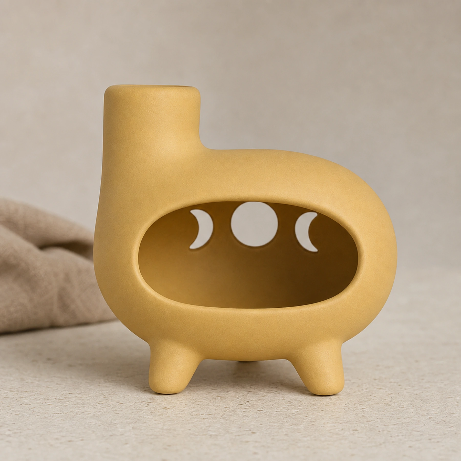 Matte yellow ceramic Palo Santo holder clean front view on a warm neutral surface