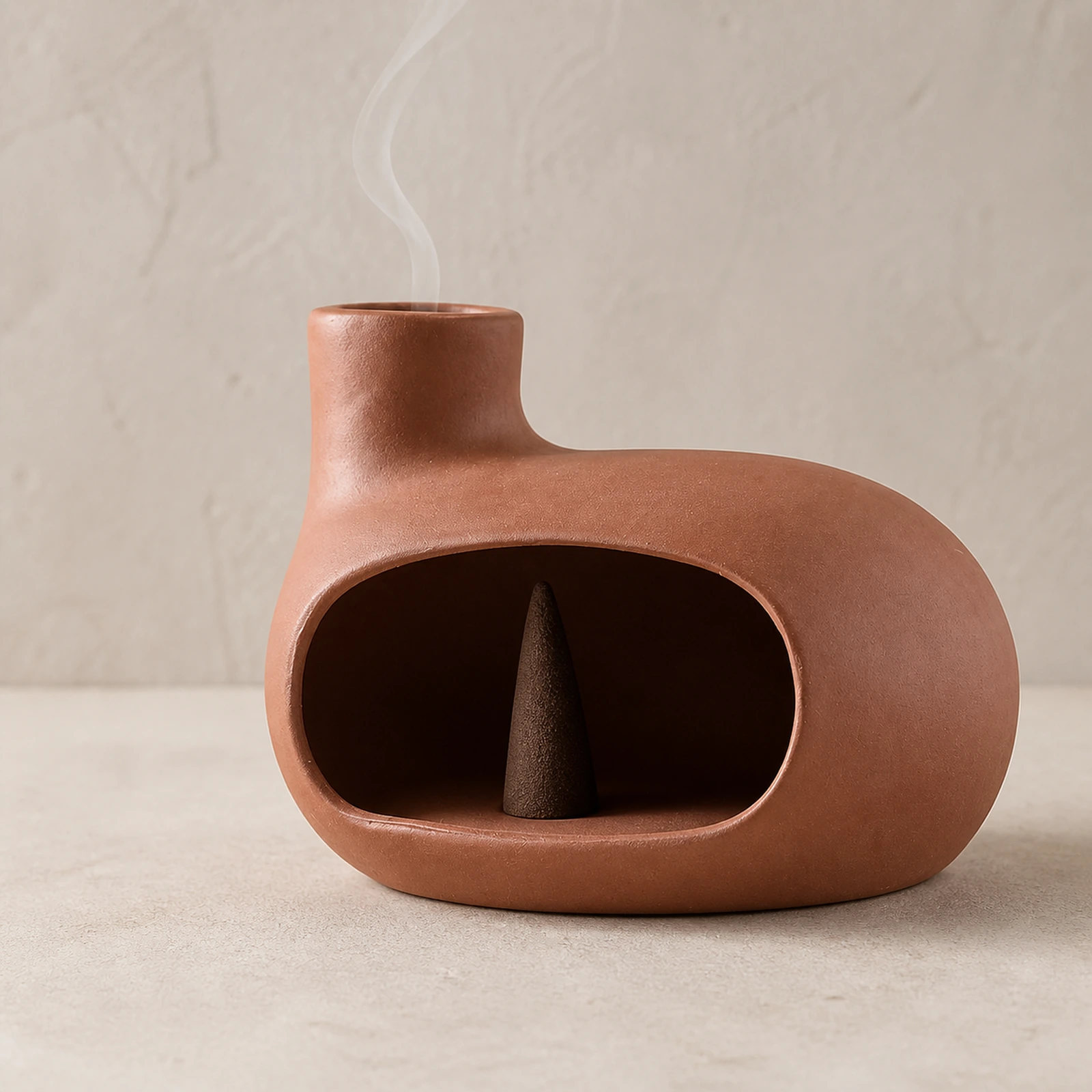 Auburn red Classic Ceramic Palo Santo & Sage Burner, using a tapered incense cone with smoke exiting the top vent.
