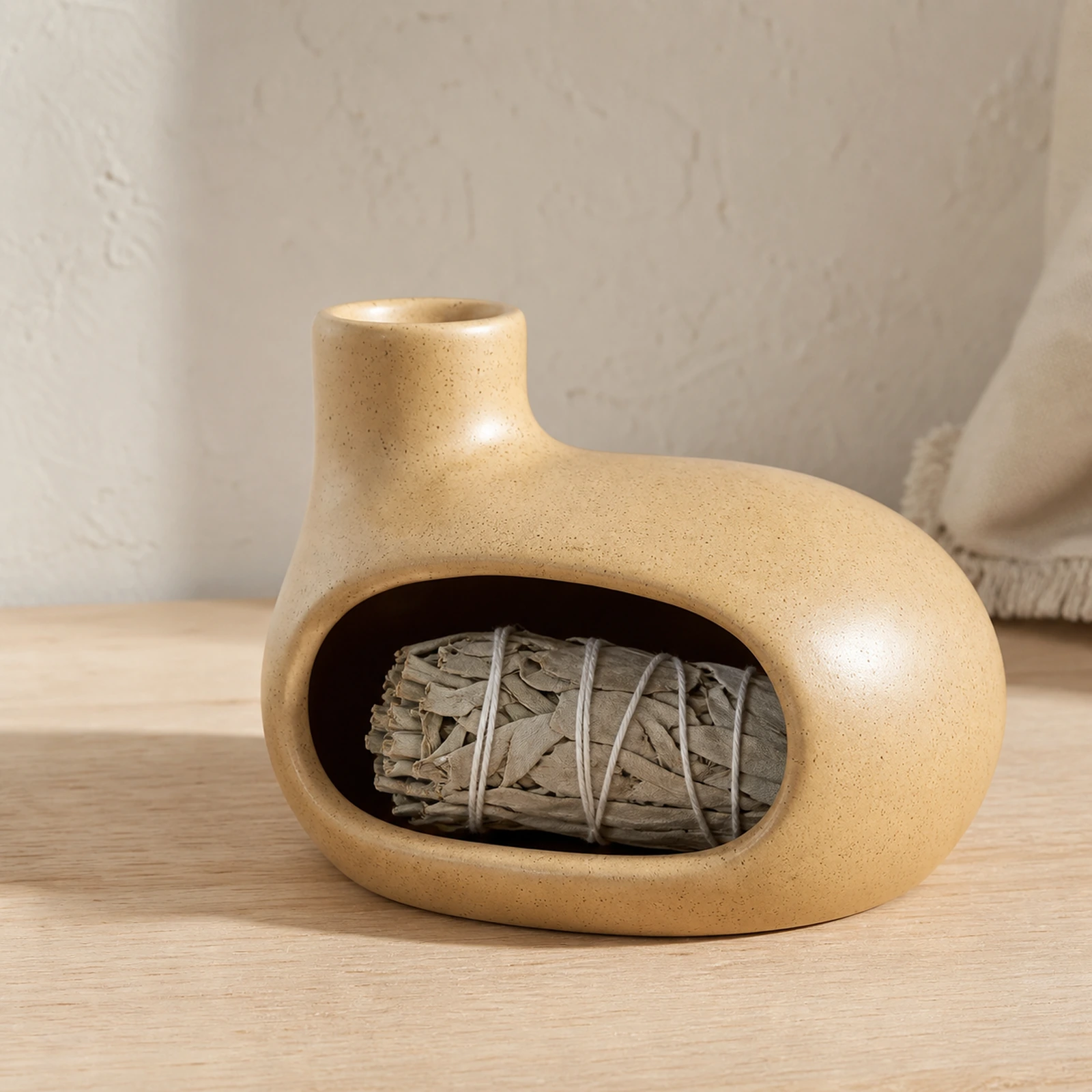 Beige Classic Ceramic Palo Santo & Sage Burner, home scene with an unlit white sage bundle in the front chamber.