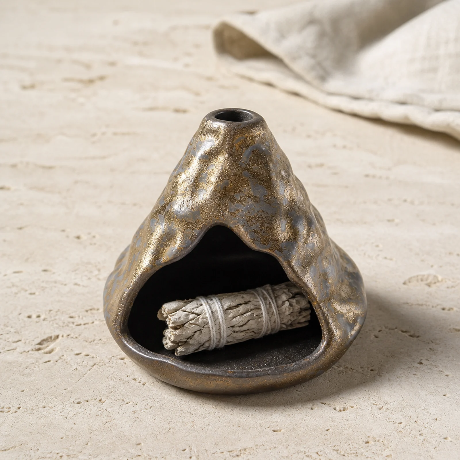 Black-Gold ceramic zongzi incense holder with a short unlit sage piece resting inside