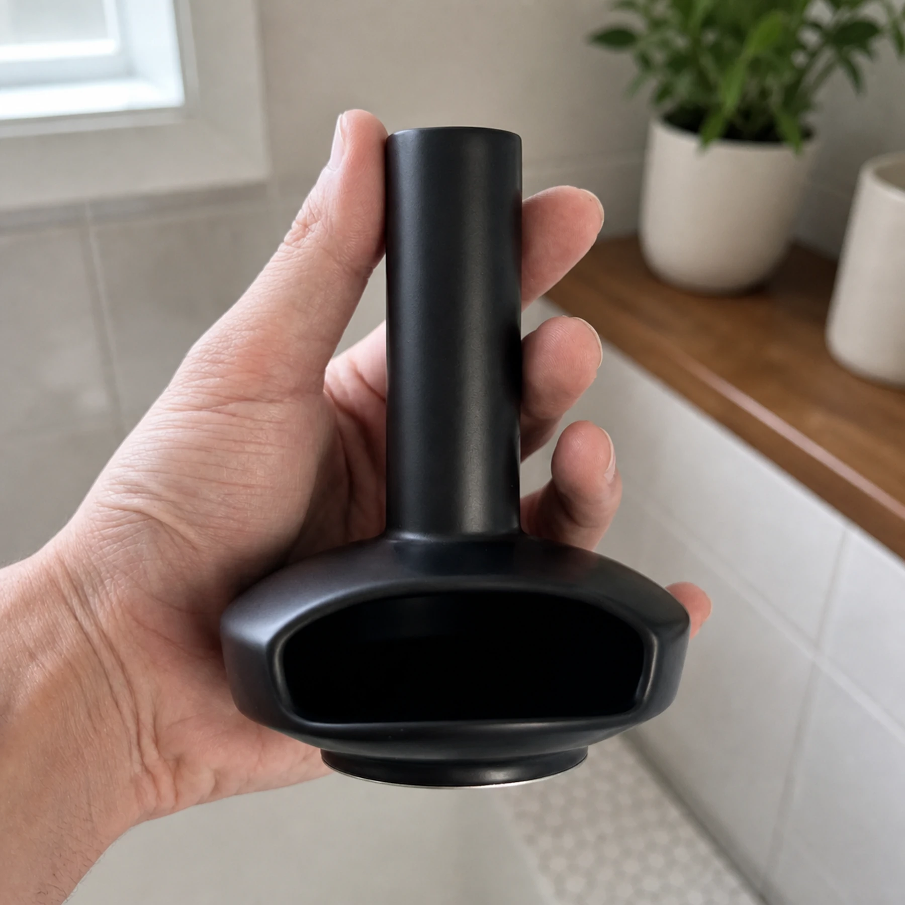 Black mini ceramic Palo Santo burner shown at hand scale