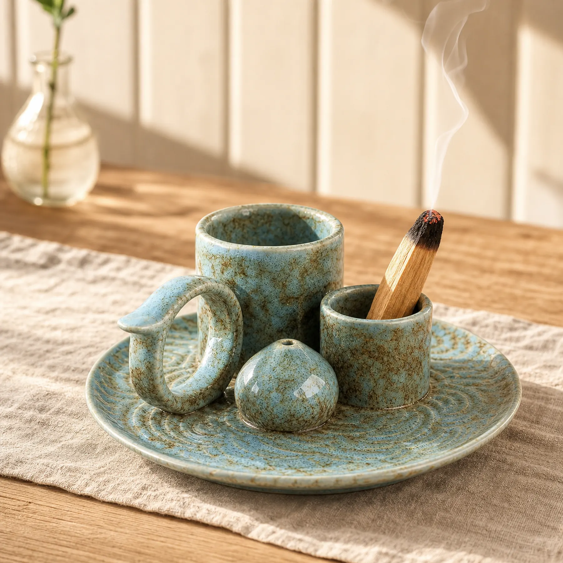 Blue glaze 5-in-1 ceramic smudge bowl with visible-tip smoldering Palo Santo and a thin smoke curl