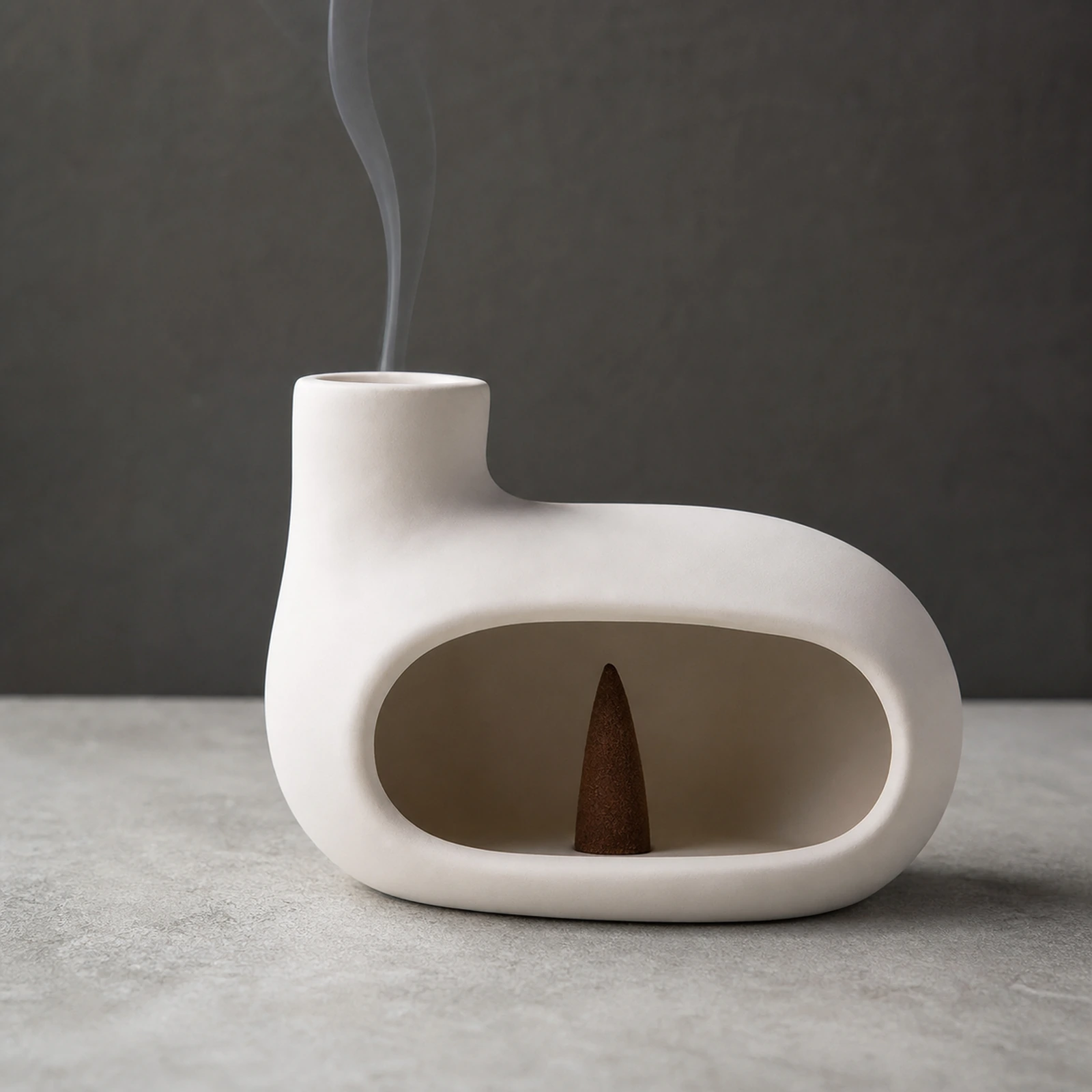 Bright Moon White elongated Classic Ceramic Palo Santo & Sage Burner, using a tapered incense cone with smoke exiting the top vent.