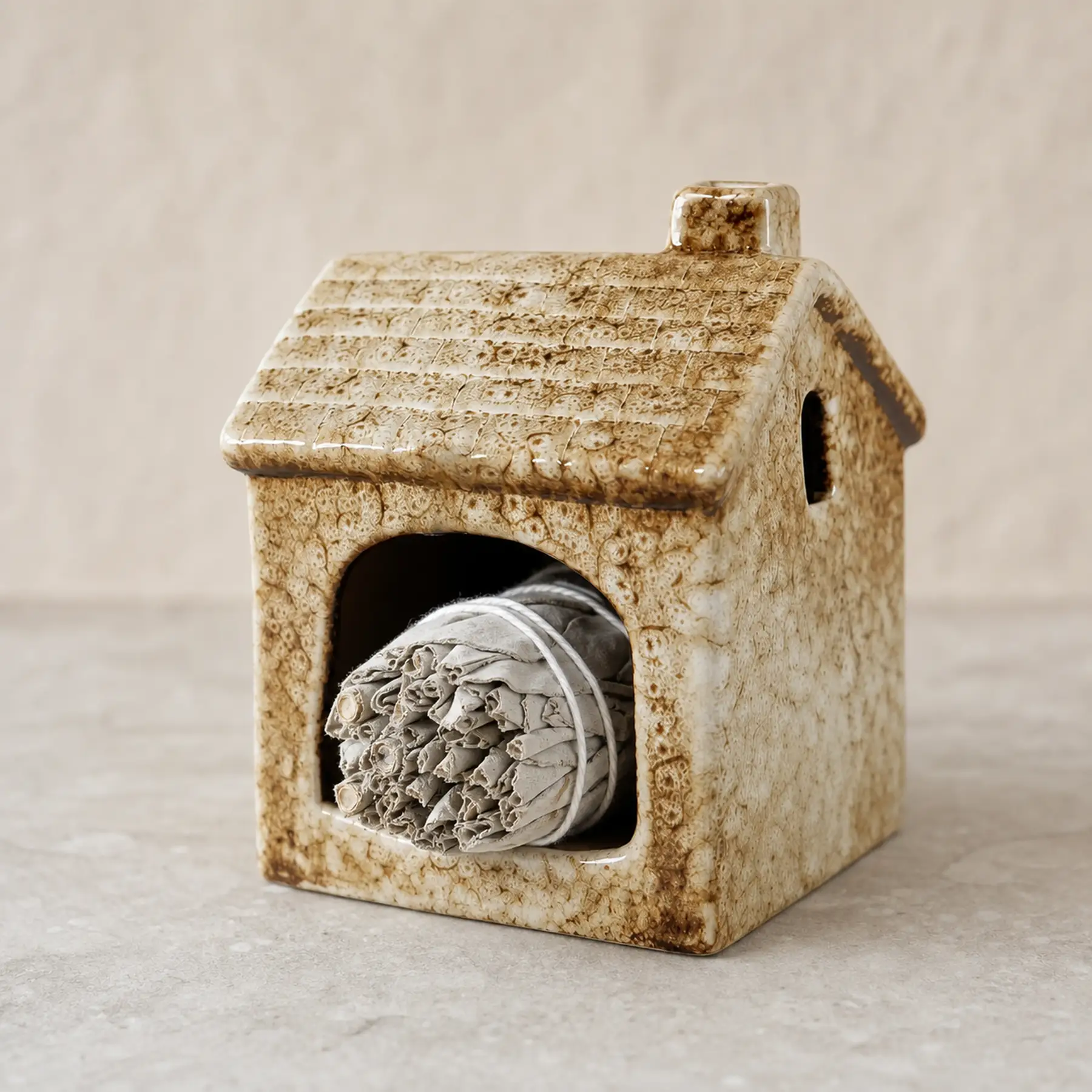 Brown ceramic house Palo Santo holder material and use detail