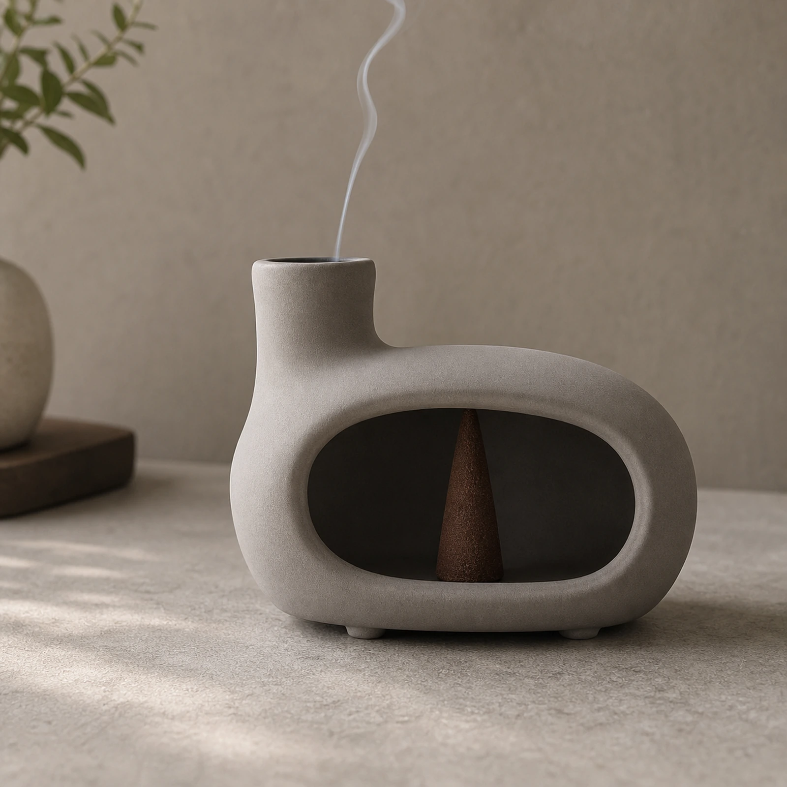 Brown gray elongated Classic Ceramic Palo Santo & Sage Burner, using a tapered incense cone with smoke exiting the top vent.