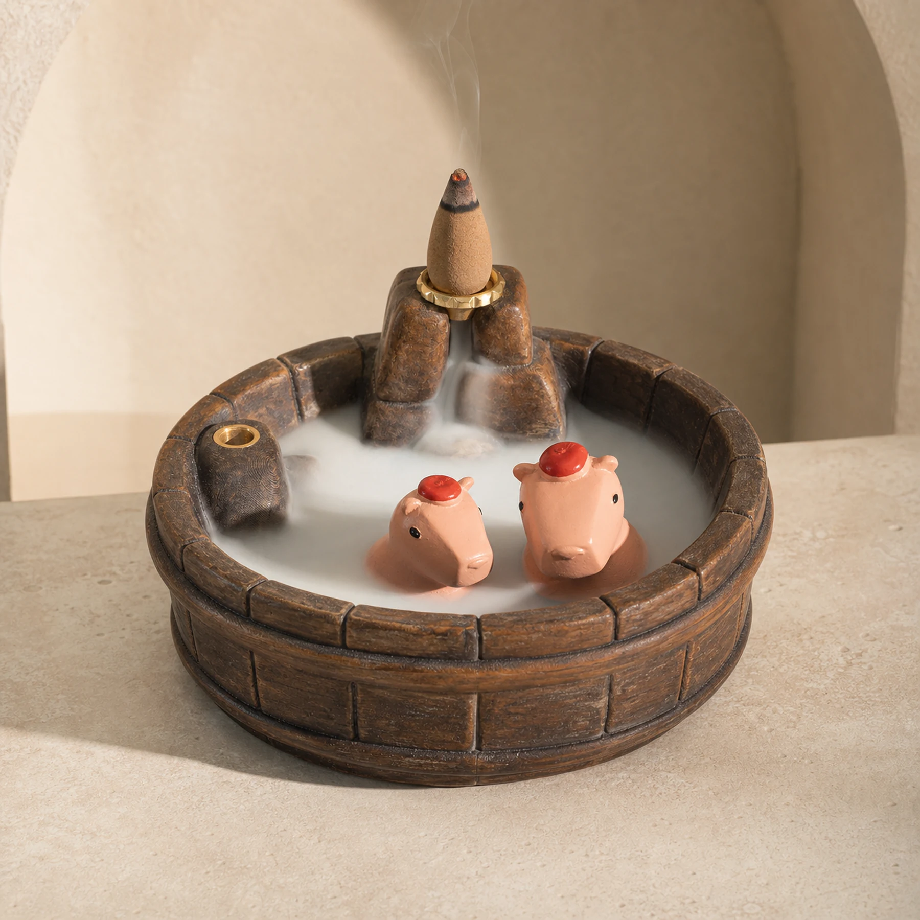 Brown wood-grain resin capybara backflow incense burner with a smoldering cone and descending waterfall smoke