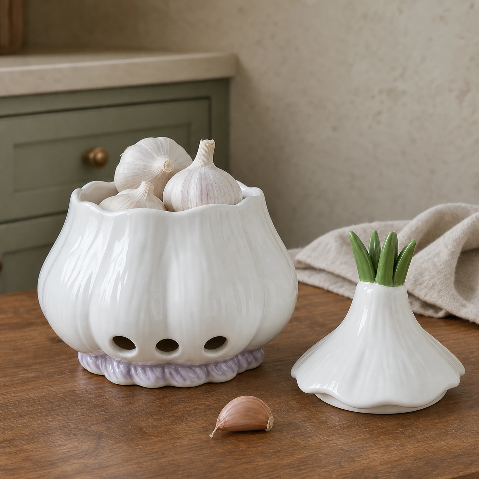 Open ceramic garlic keeper holding whole garlic bulbs with its sprout lid beside it