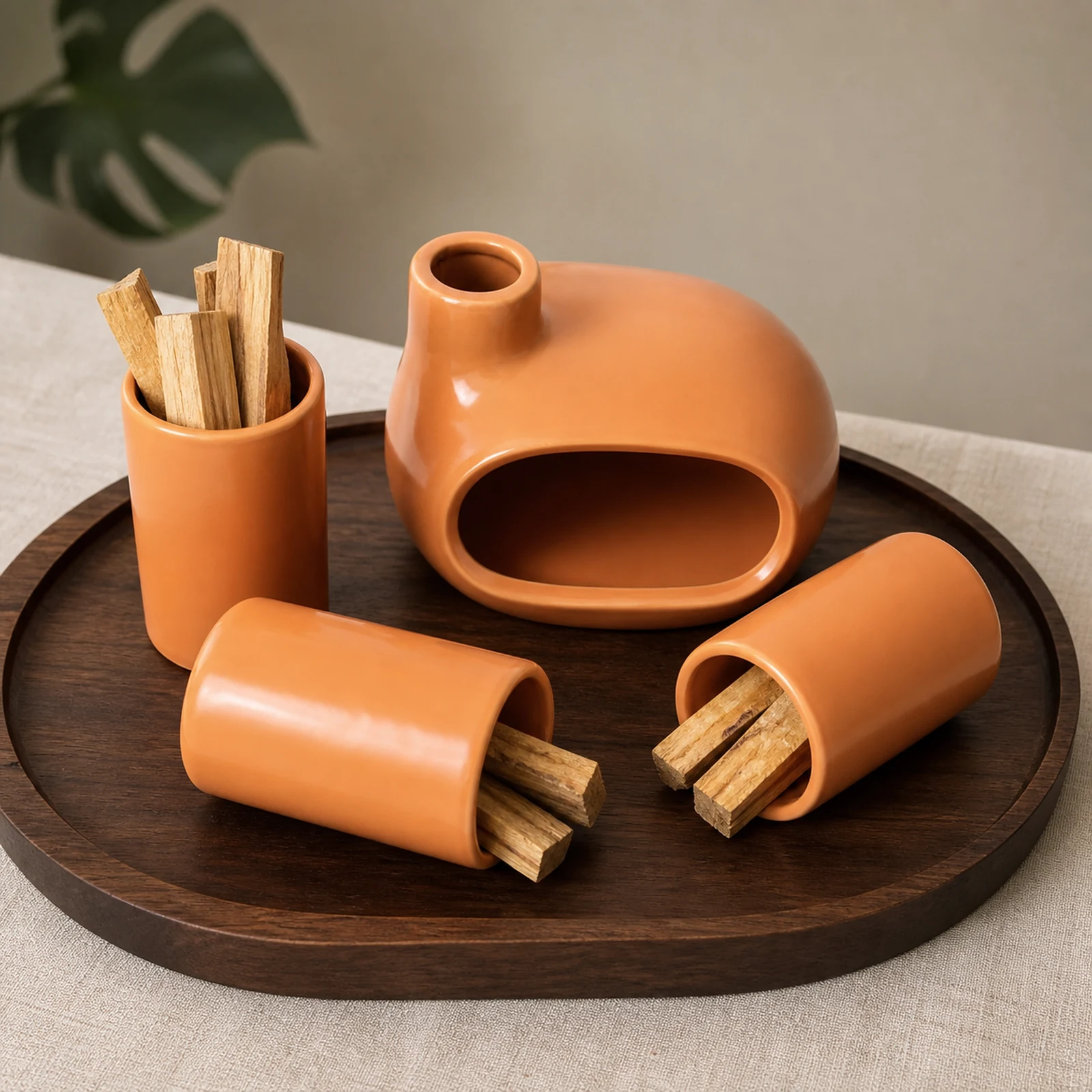 Ceramic Palo Santo burner set with three holders organizing unlit wood on a walnut tray