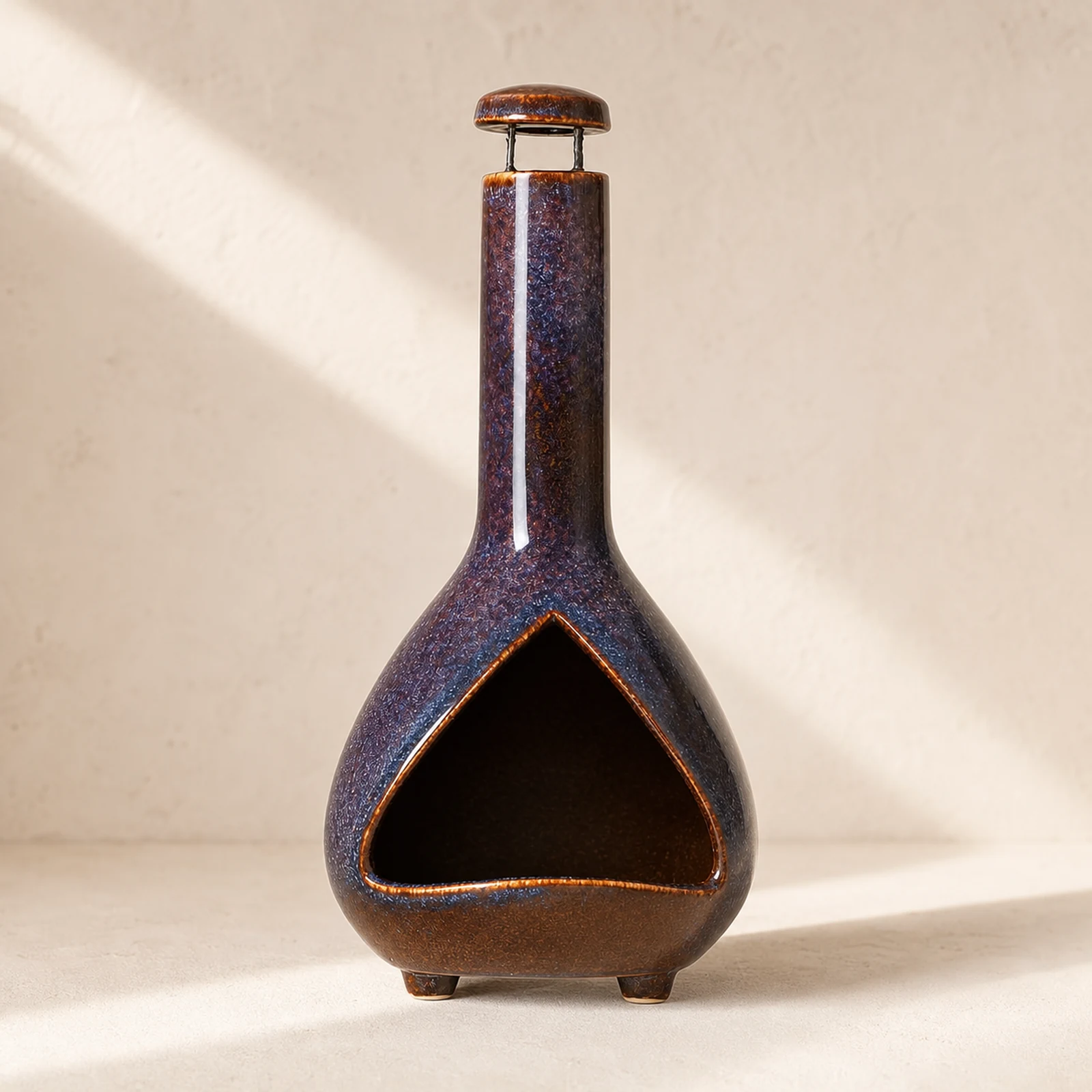 Color Glaze deep plum-blue ceramic Palo Santo holder shown empty from the front on a warm neutral surface