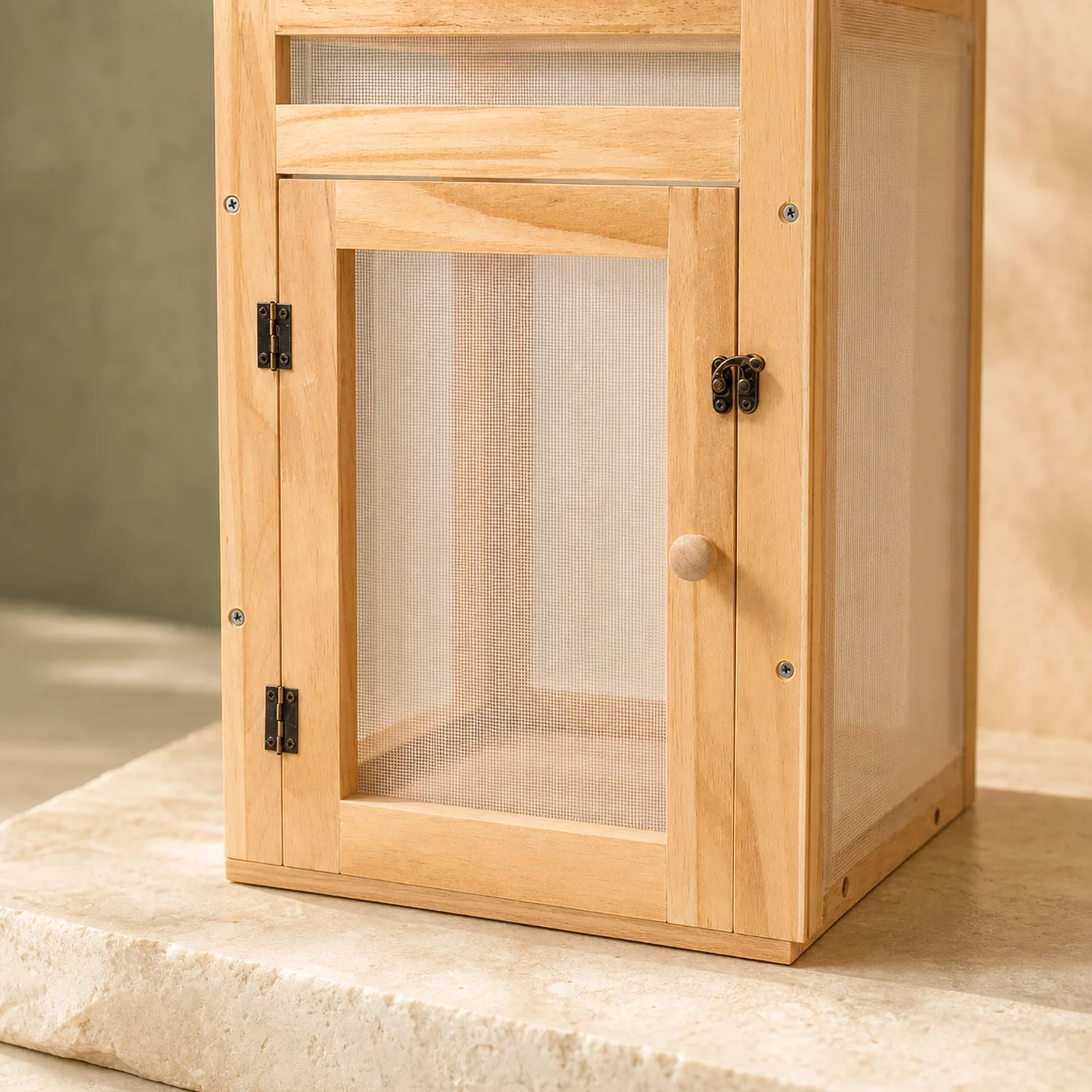 Solid wood base and dark door hardware detail on the compact butterfly habitat
