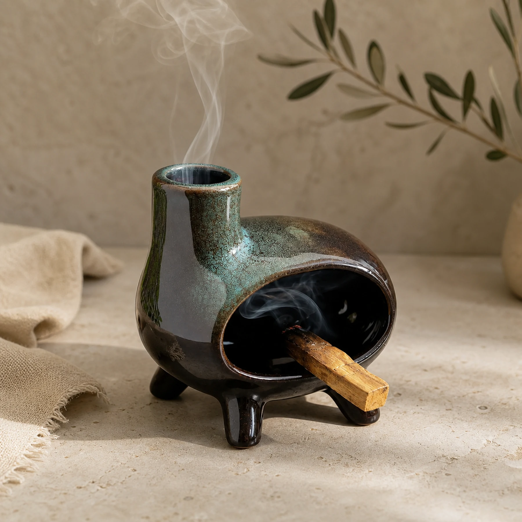 Green glaze ceramic Palo Santo holder burning Palo Santo with smoke rising from the top chimney