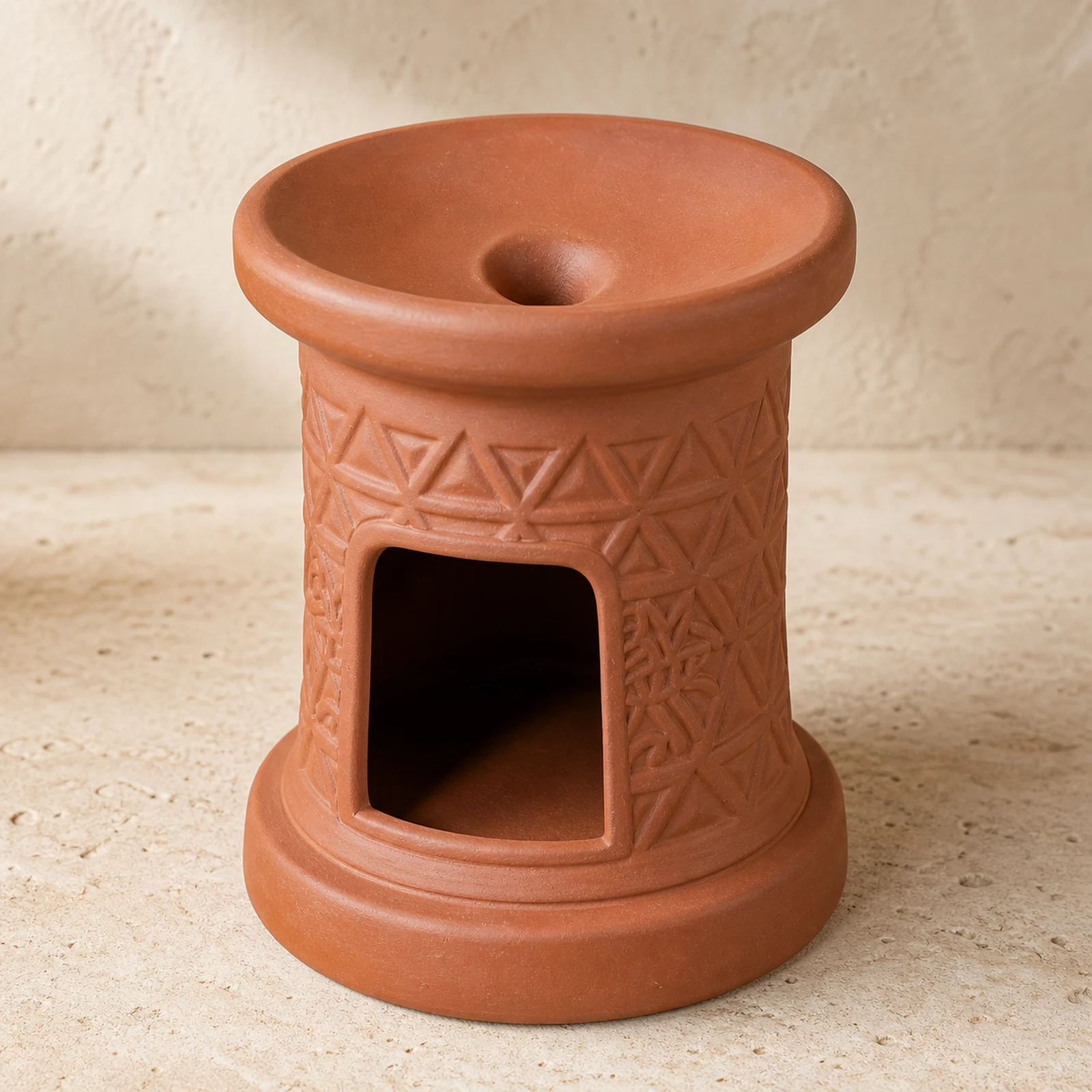 Brick-red terracotta incense burner with a top groove, geometric relief, and front storage opening