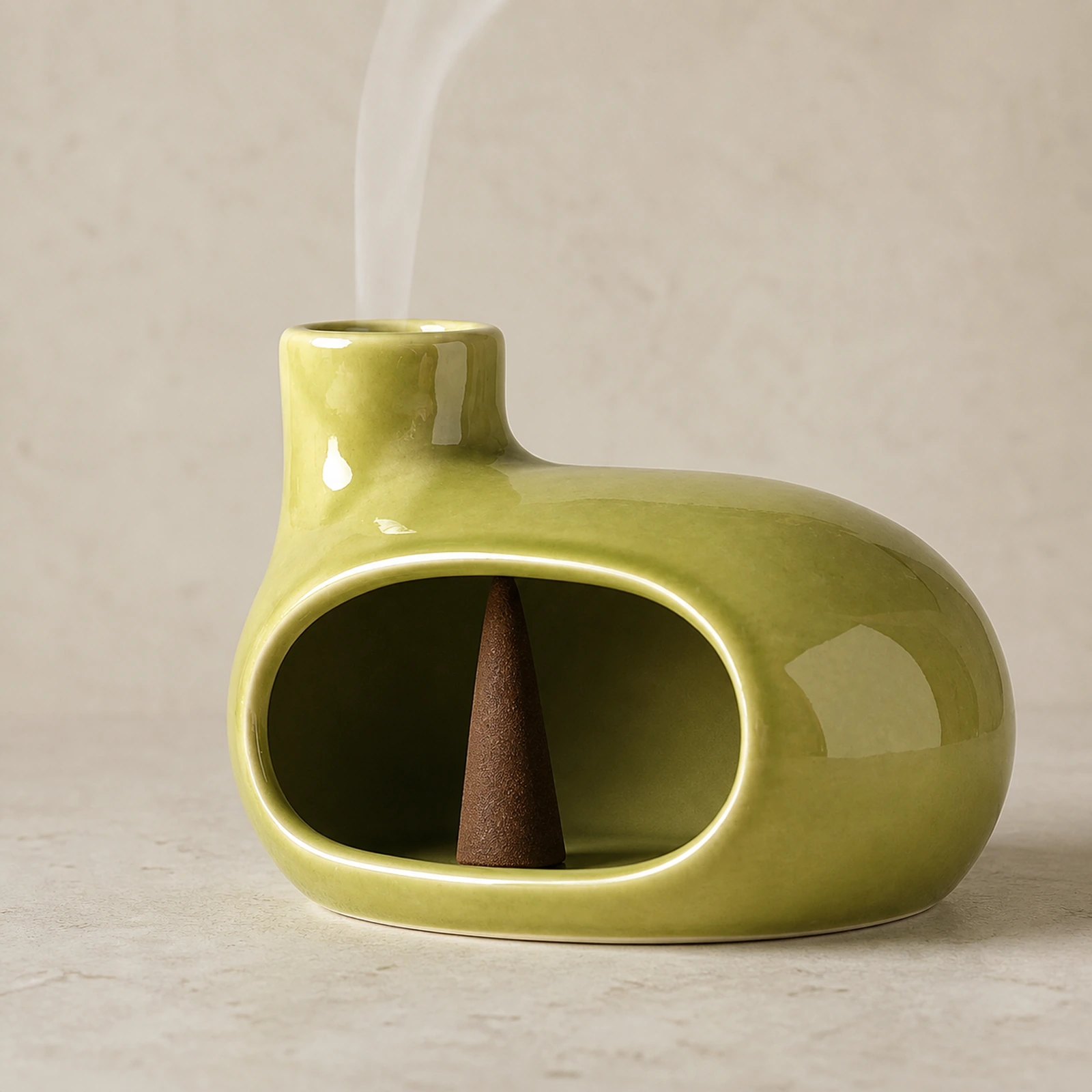 Emerald green Classic Ceramic Palo Santo & Sage Burner, using a tapered incense cone with smoke exiting the top vent.