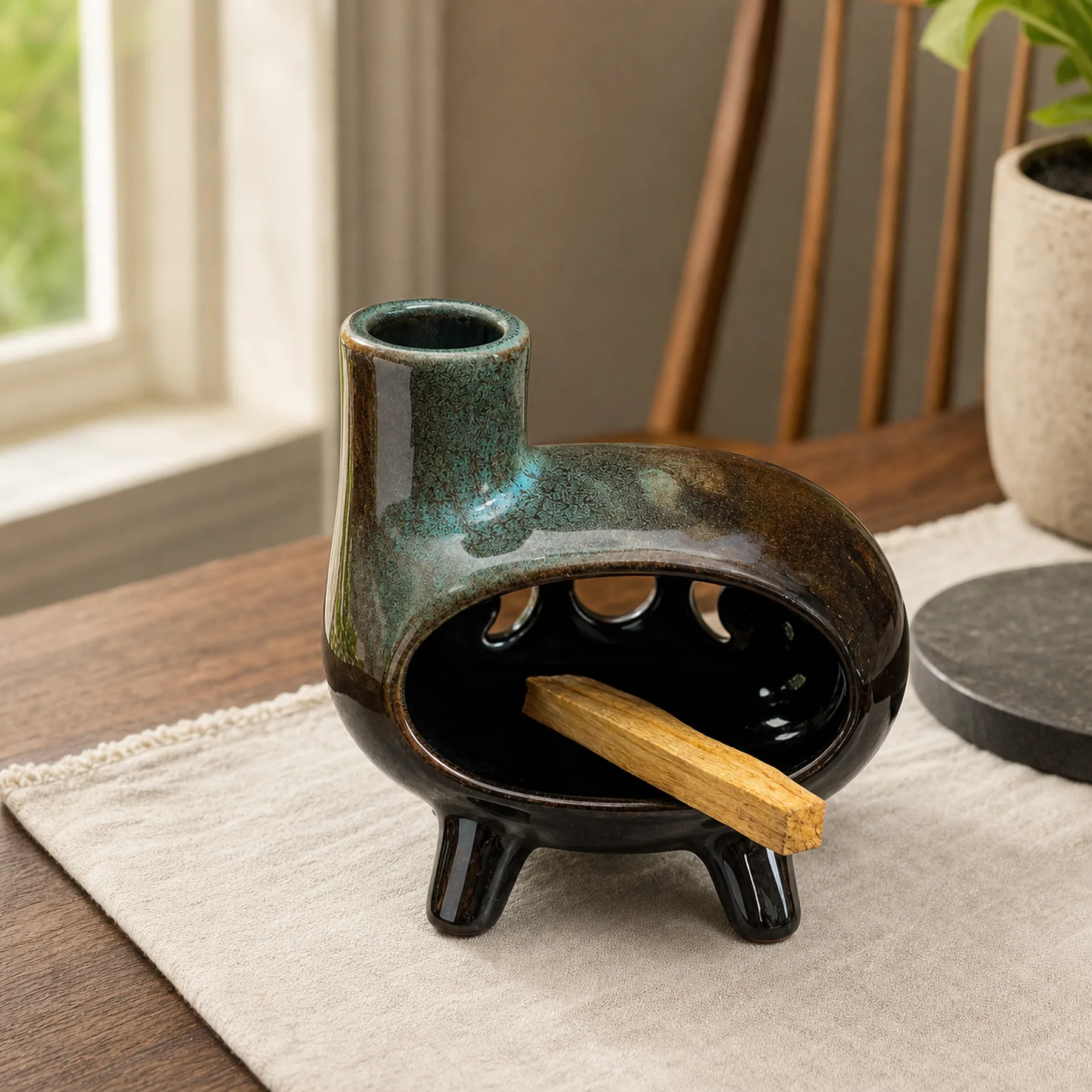 Green glaze ceramic Palo Santo holder with an unlit Palo Santo stick placed in the chamber