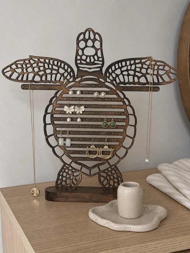 Turtle jewelry organizer with earrings on a customer bedroom dresser