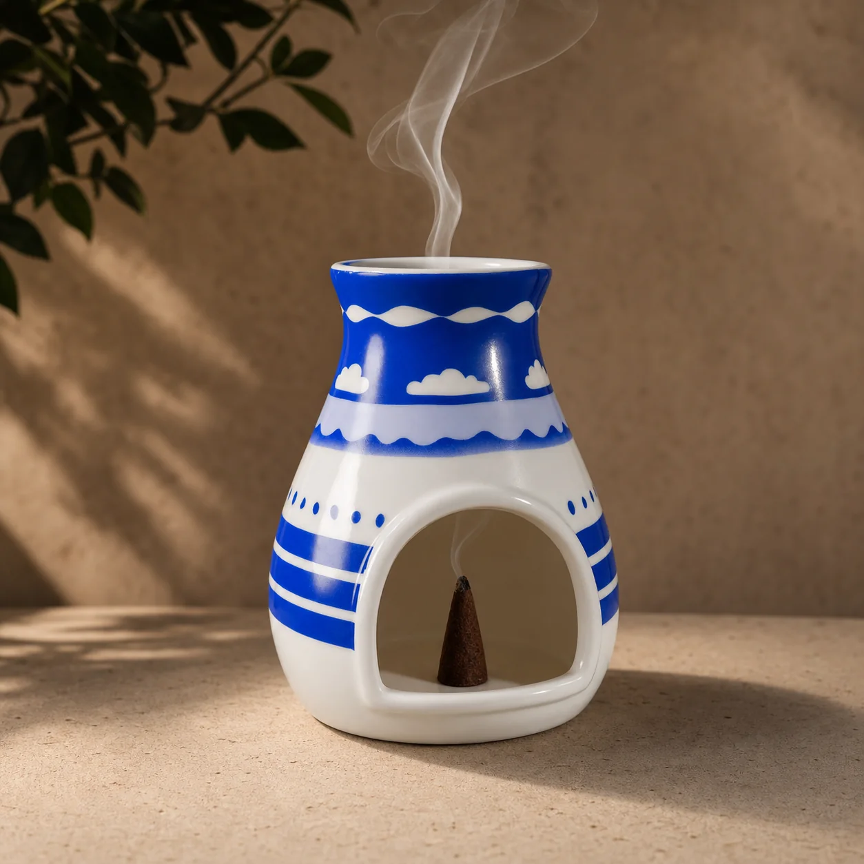 Hopi blue ceramic Palo Santo holder with a burning incense cone and smoke