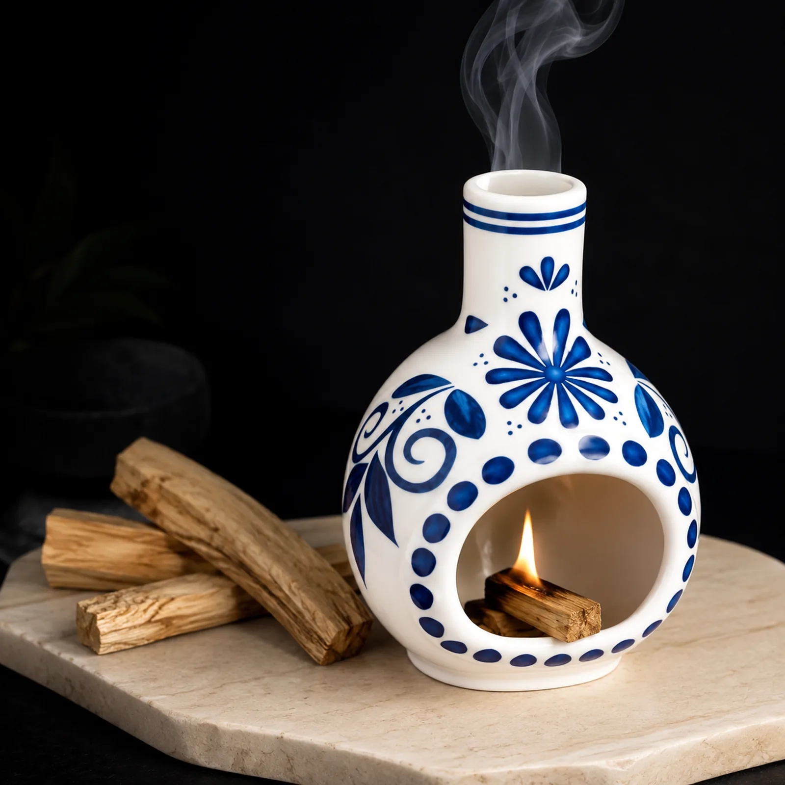 MOUGIGI blue and white ceramic Palo Santo holder dark editorial scene