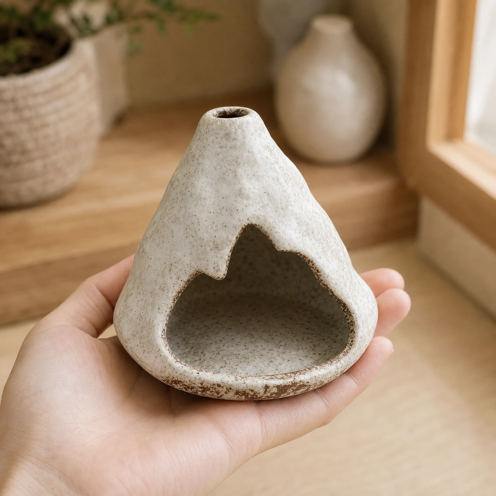 Kiln-Fired Off-White ceramic zongzi incense holder supported in one hand to show tabletop scale