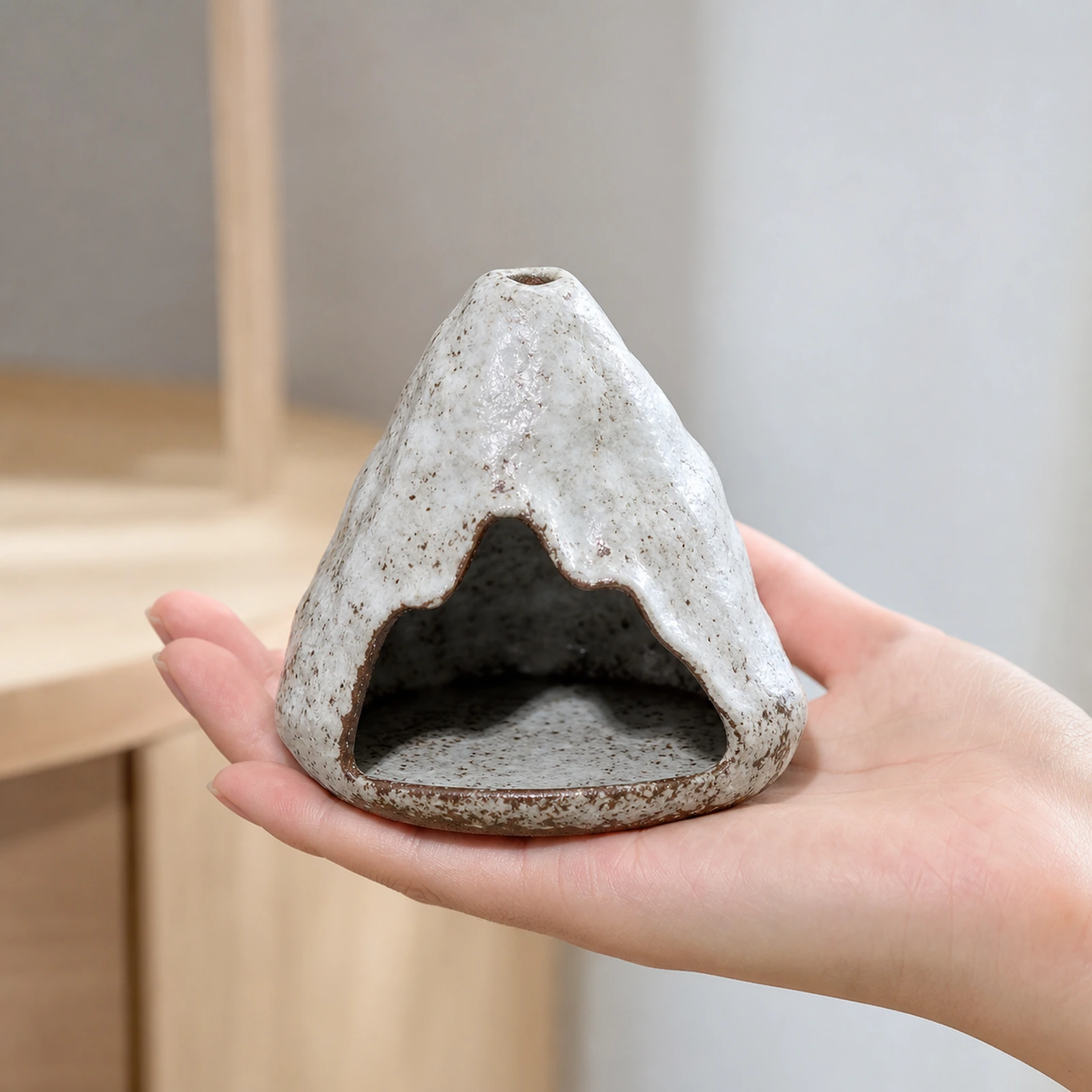 Kiln-Fired Pure White ceramic zongzi incense holder supported in one hand to show tabletop scale