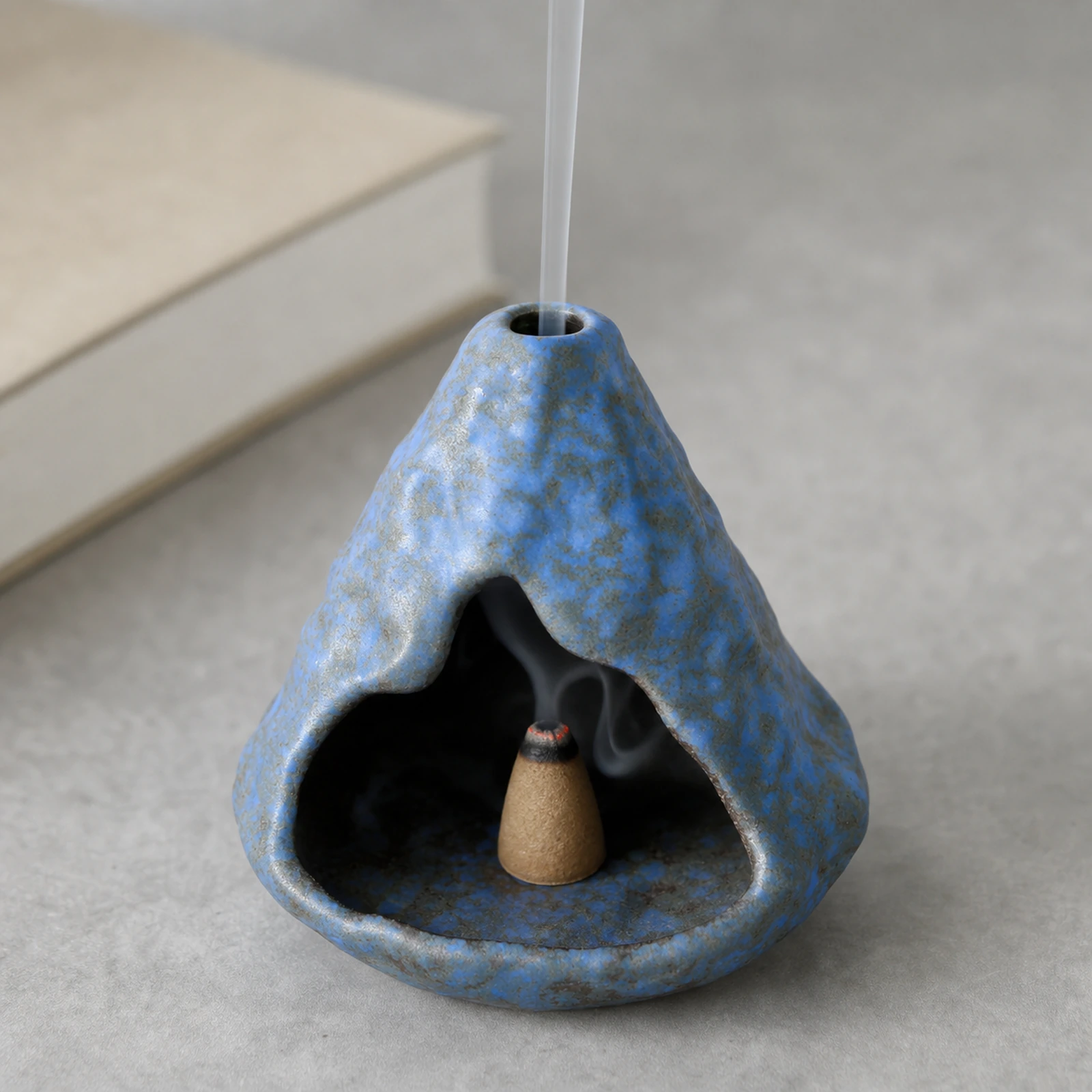 Light Blue ceramic zongzi incense holder with a tapered incense cone and smoke through the top vent