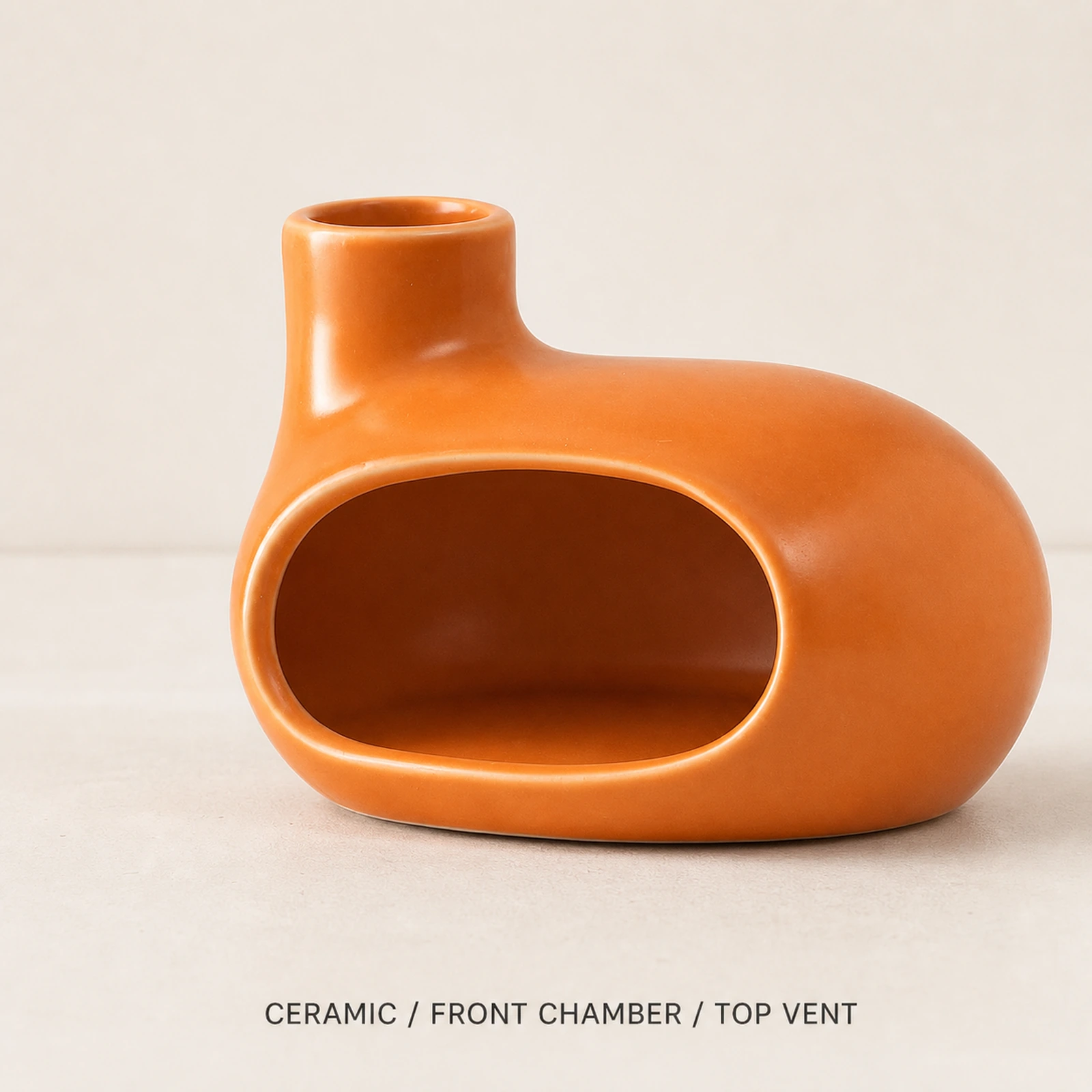 Orange Classic Ceramic Palo Santo & Sage Burner, fact view identifying the ceramic body, front chamber, and top vent.