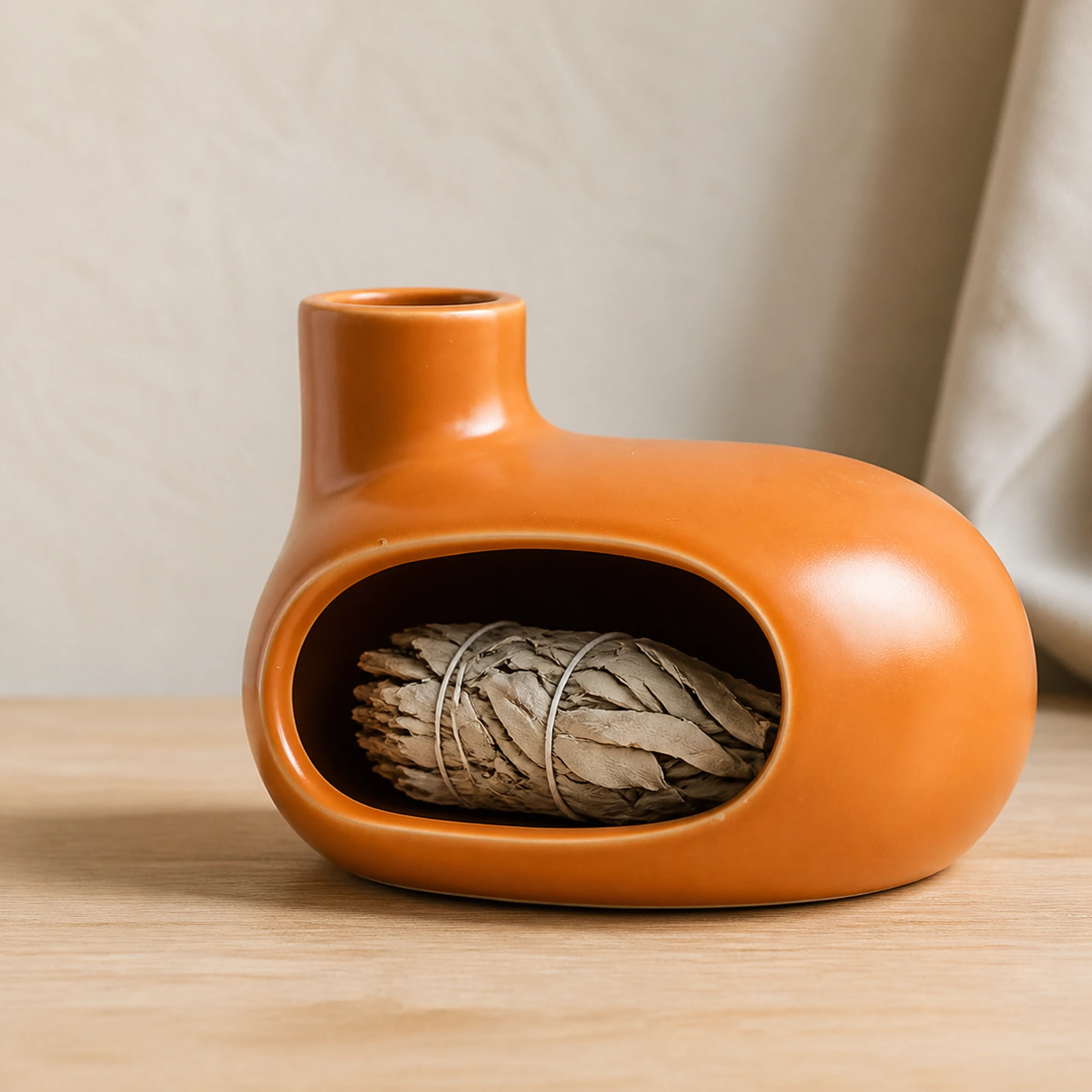 Orange Classic Ceramic Palo Santo & Sage Burner, home scene with an unlit white sage bundle in the front chamber.