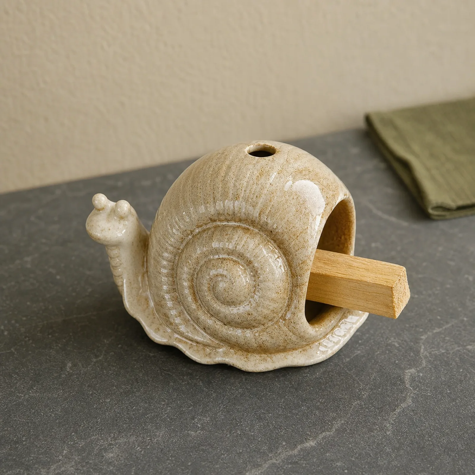 Brown ceramic snail Palo Santo holder showing smoke-free wood placement in the front chamber
