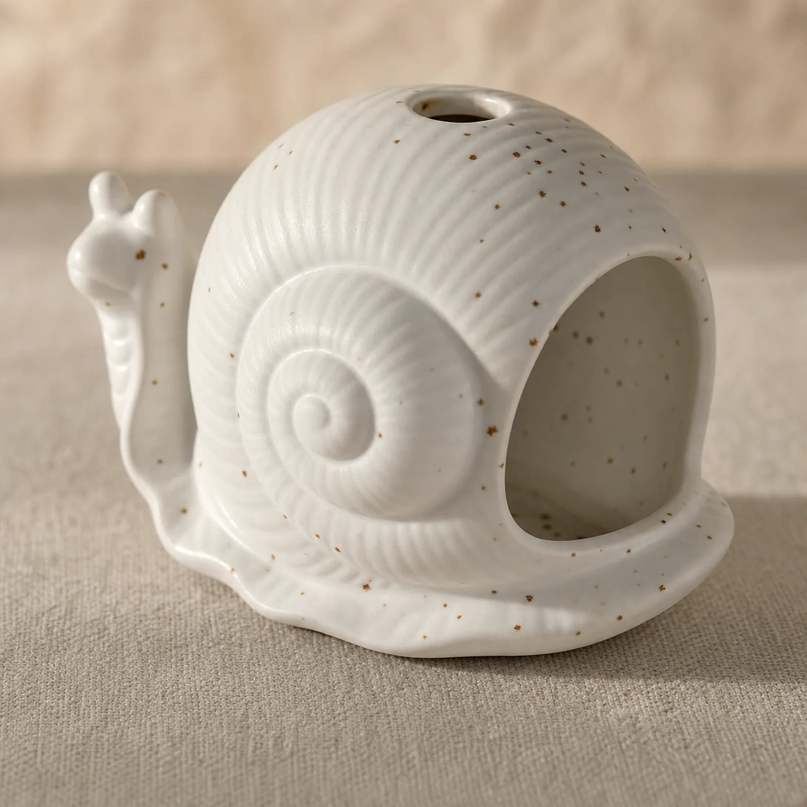 White ceramic snail burner spiral shell glaze and top vent detail