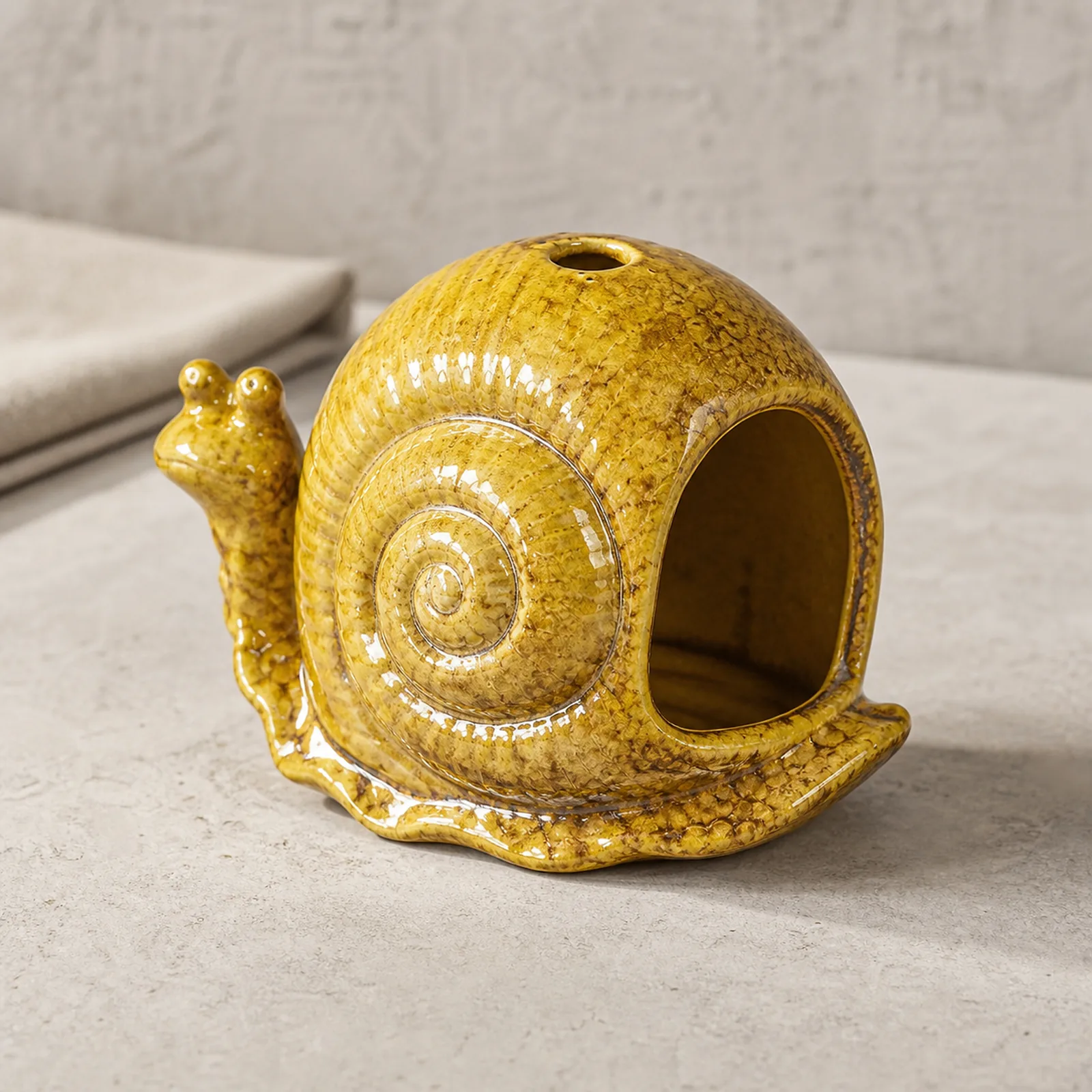 Yellow ceramic snail incense burner clean three-quarter product view