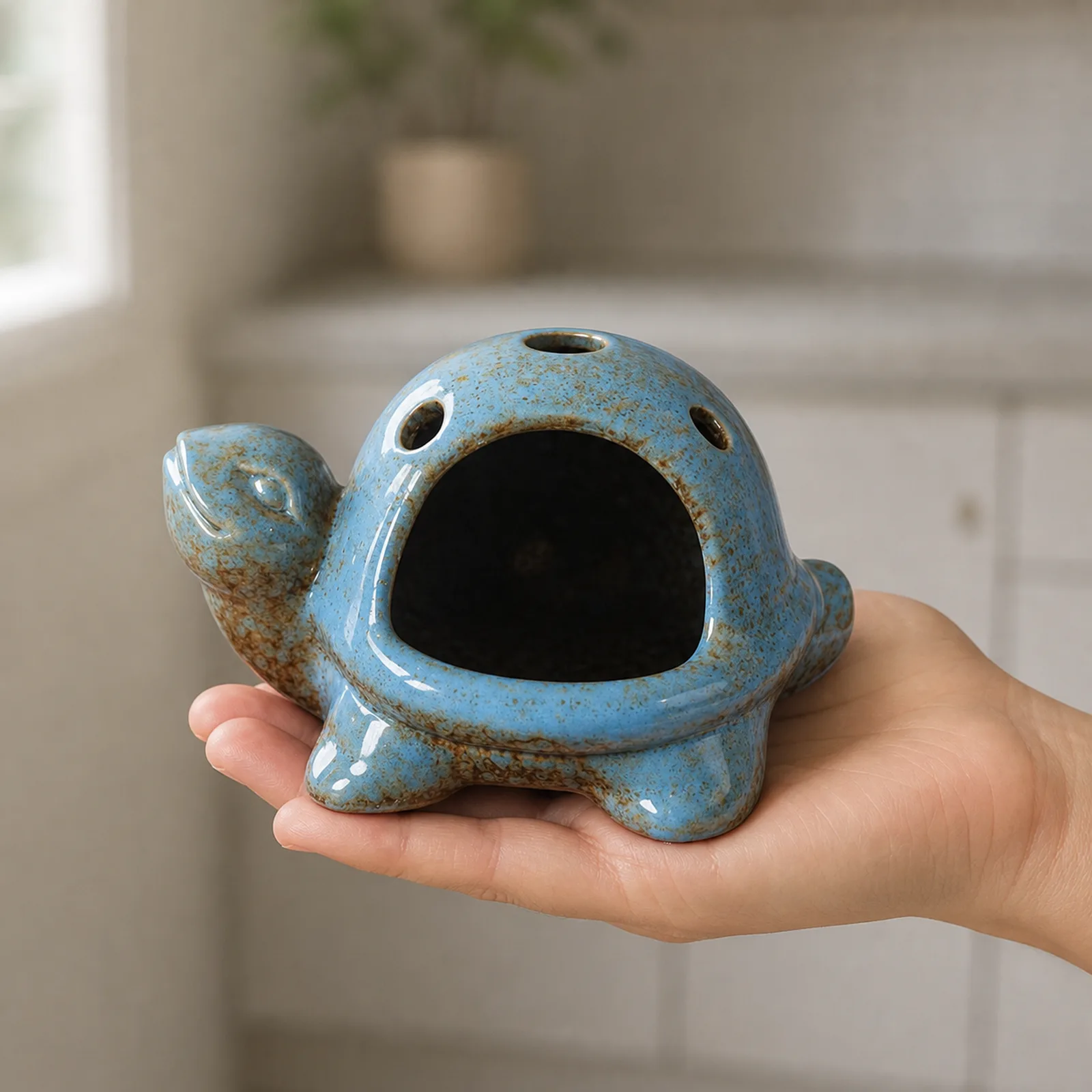 Blue speckled ceramic turtle Palo Santo holder hand scale view