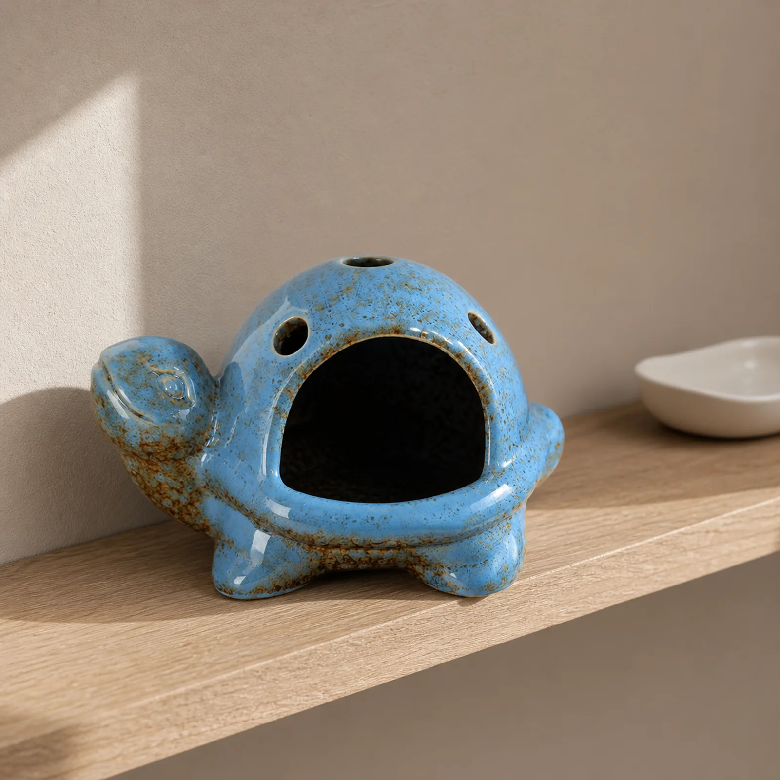 Blue speckled ceramic turtle Palo Santo holder home shelf lifestyle