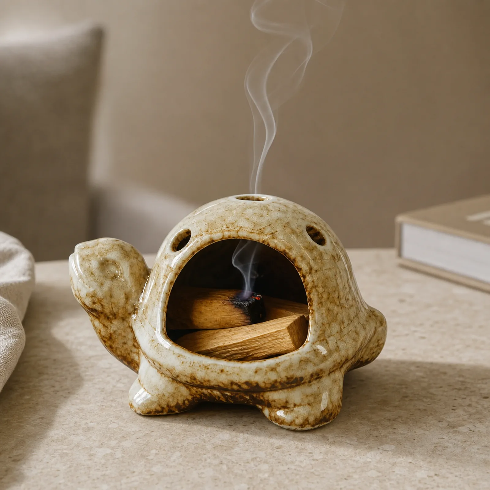 Brown ceramic turtle Palo Santo holder with a visible glowing ember and thin smoke exiting the top opening