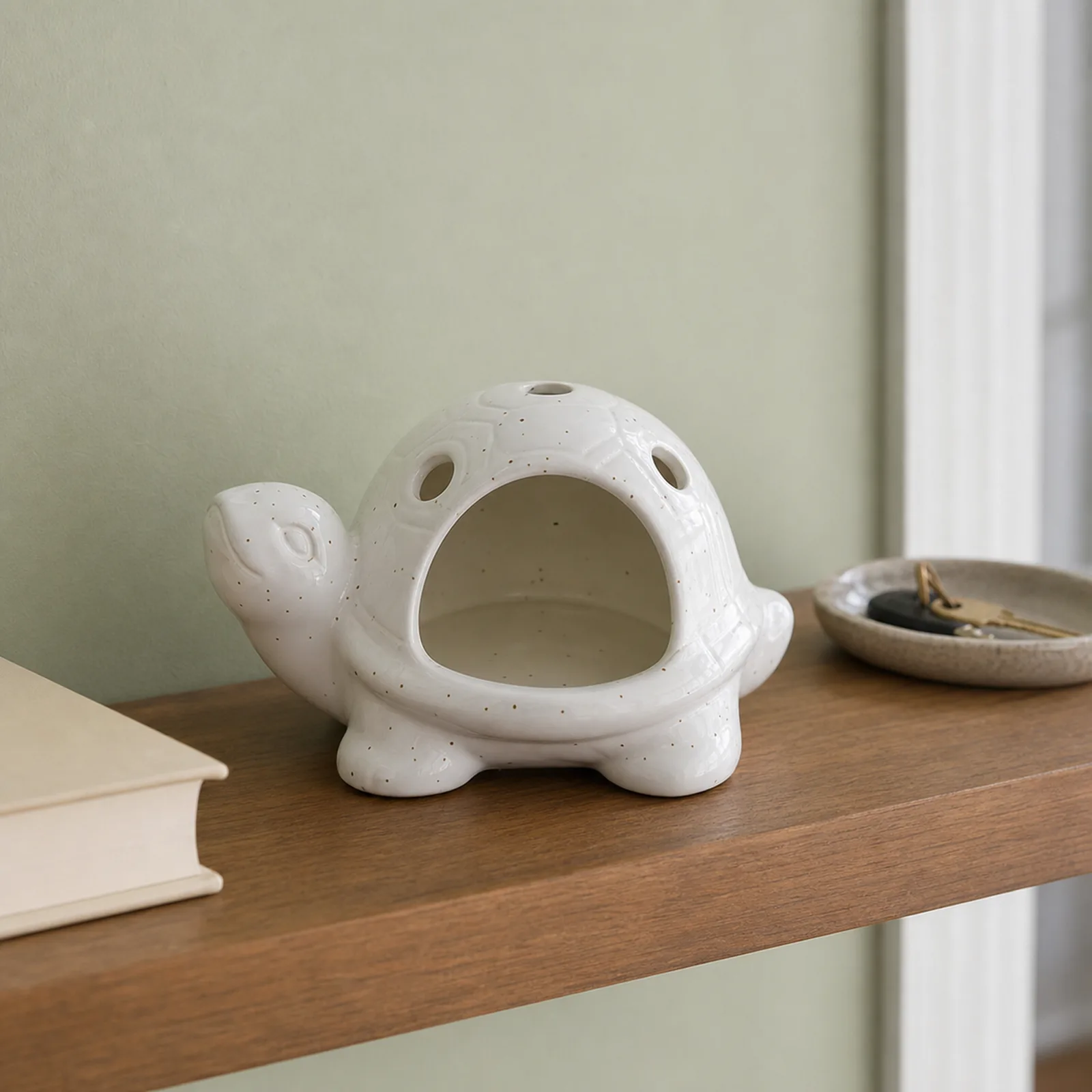White speckled ceramic turtle Palo Santo holder home shelf lifestyle