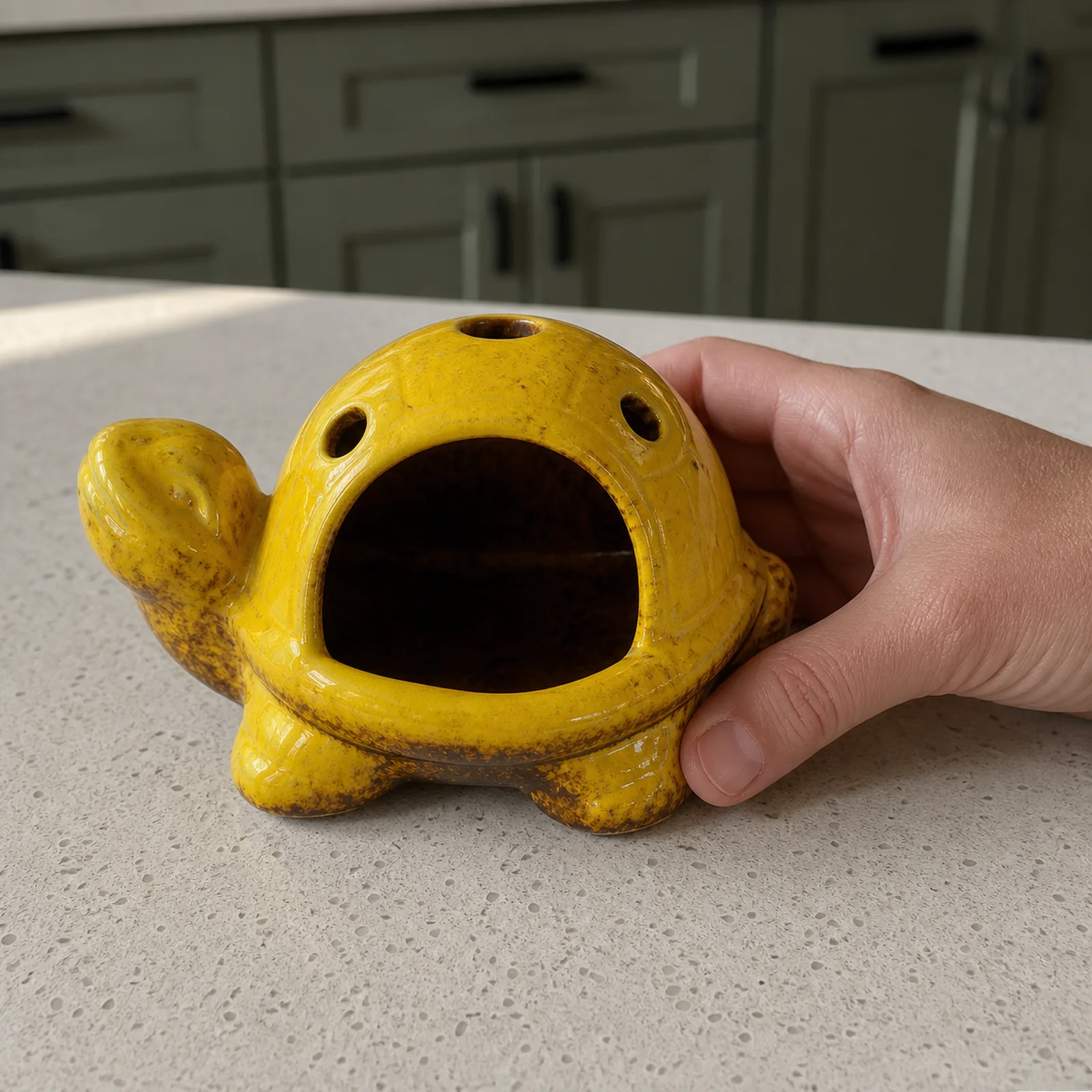 Yellow kiln-effect ceramic turtle Palo Santo holder hand scale view