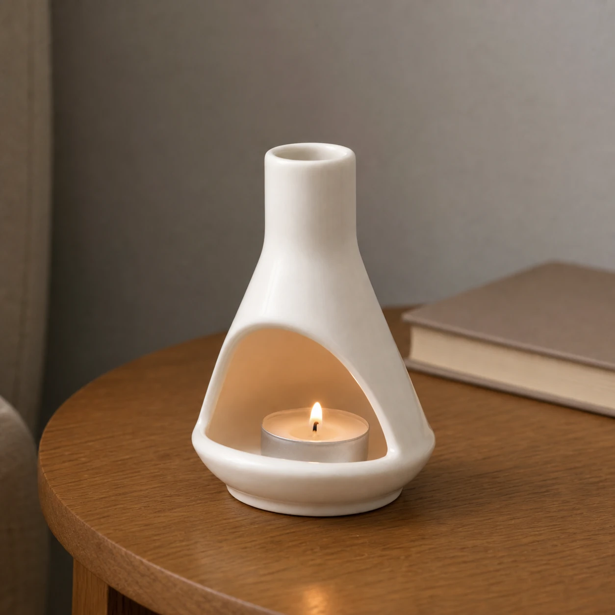 White ceramic mini chiminea with small tealight inside hearth