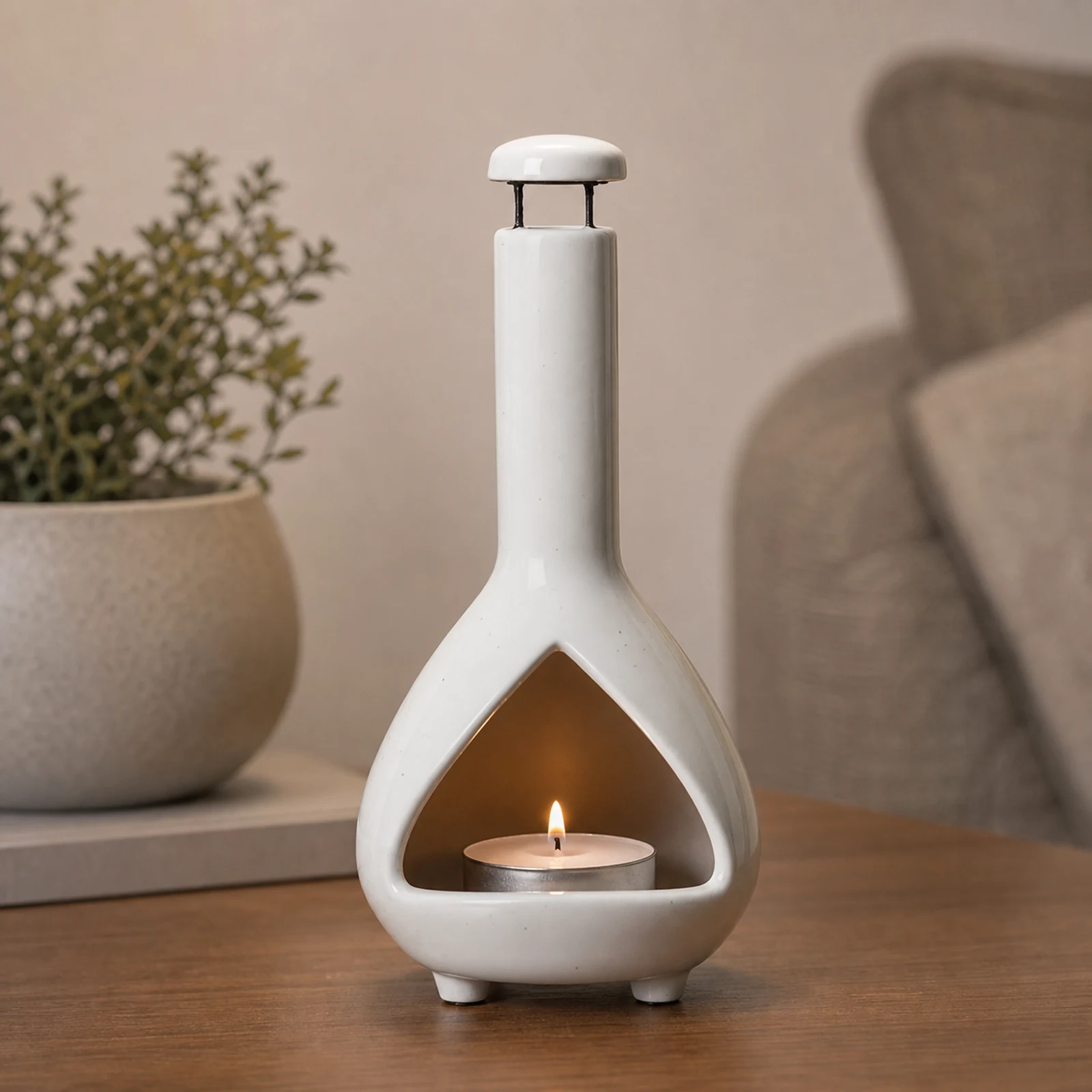 White ceramic Palo Santo holder with a small lit tea light candle in the front chamber