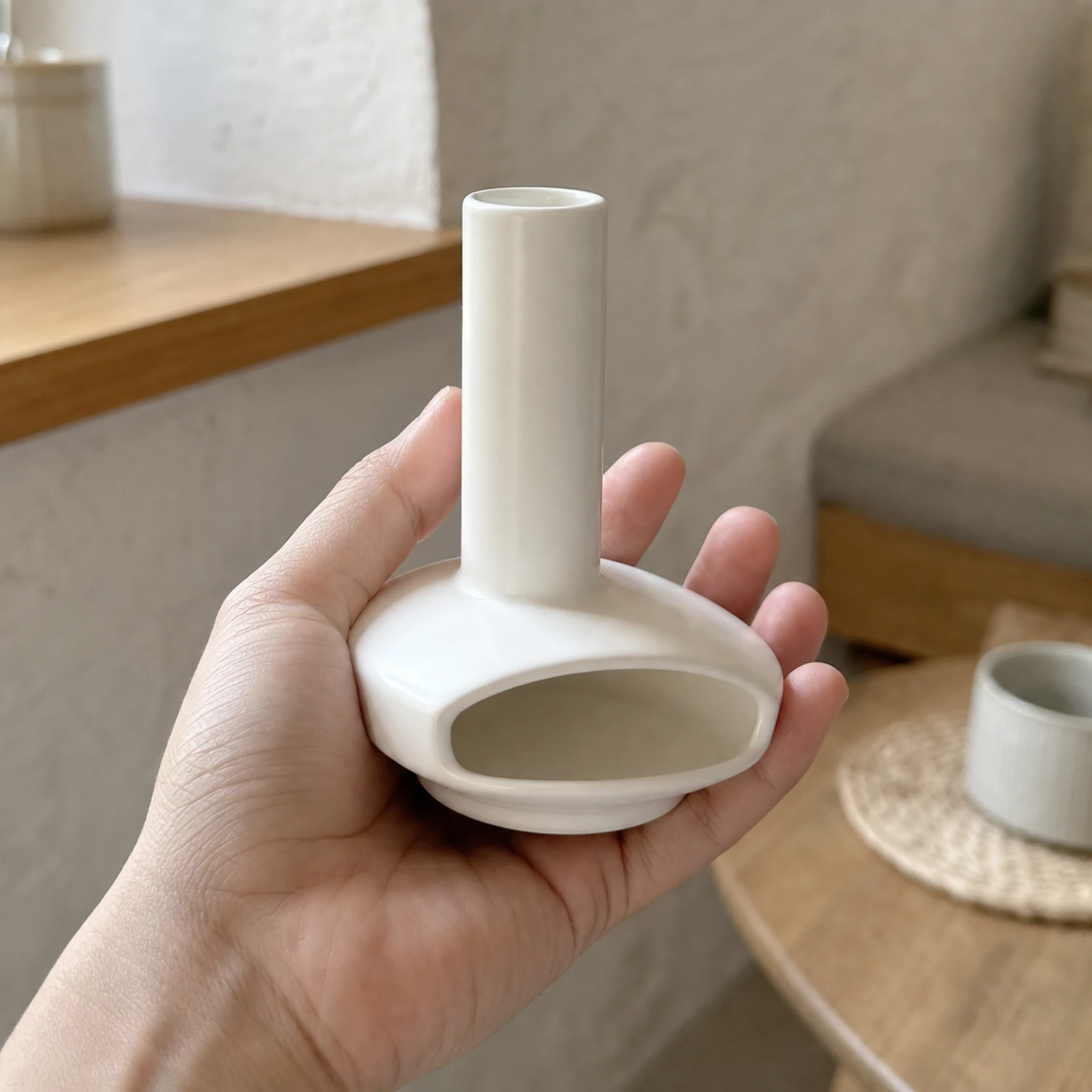 White mini ceramic Palo Santo burner shown at hand scale