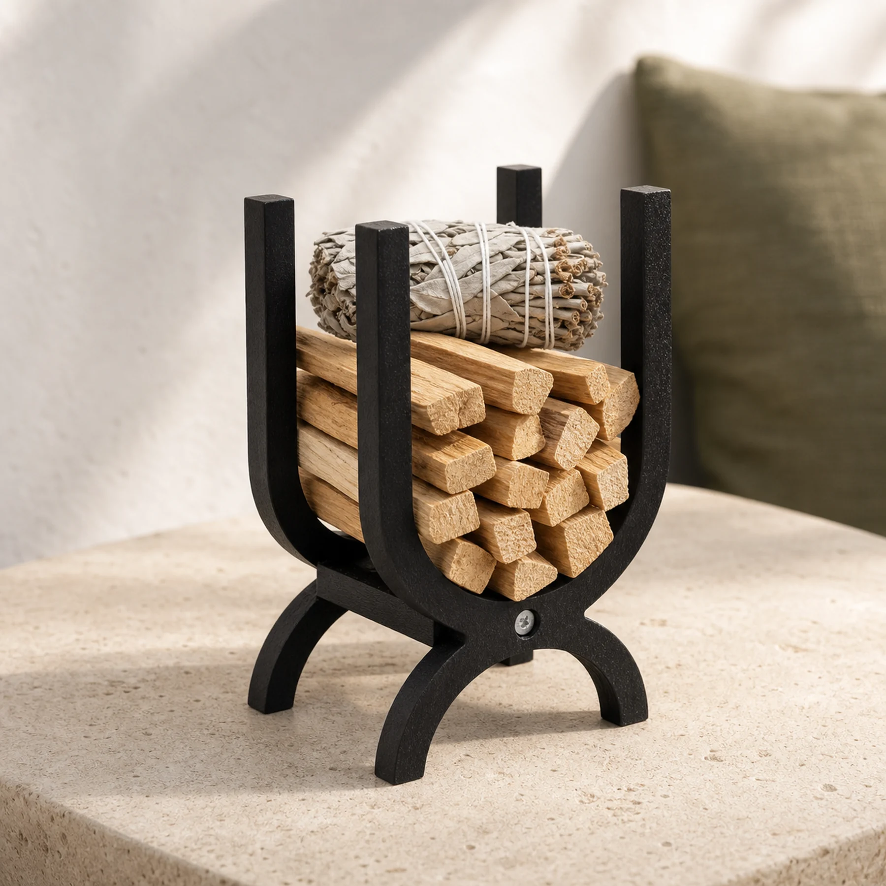 Dark wood Palo Santo and sage storage organizer holding unlit materials on a naturally lit side table