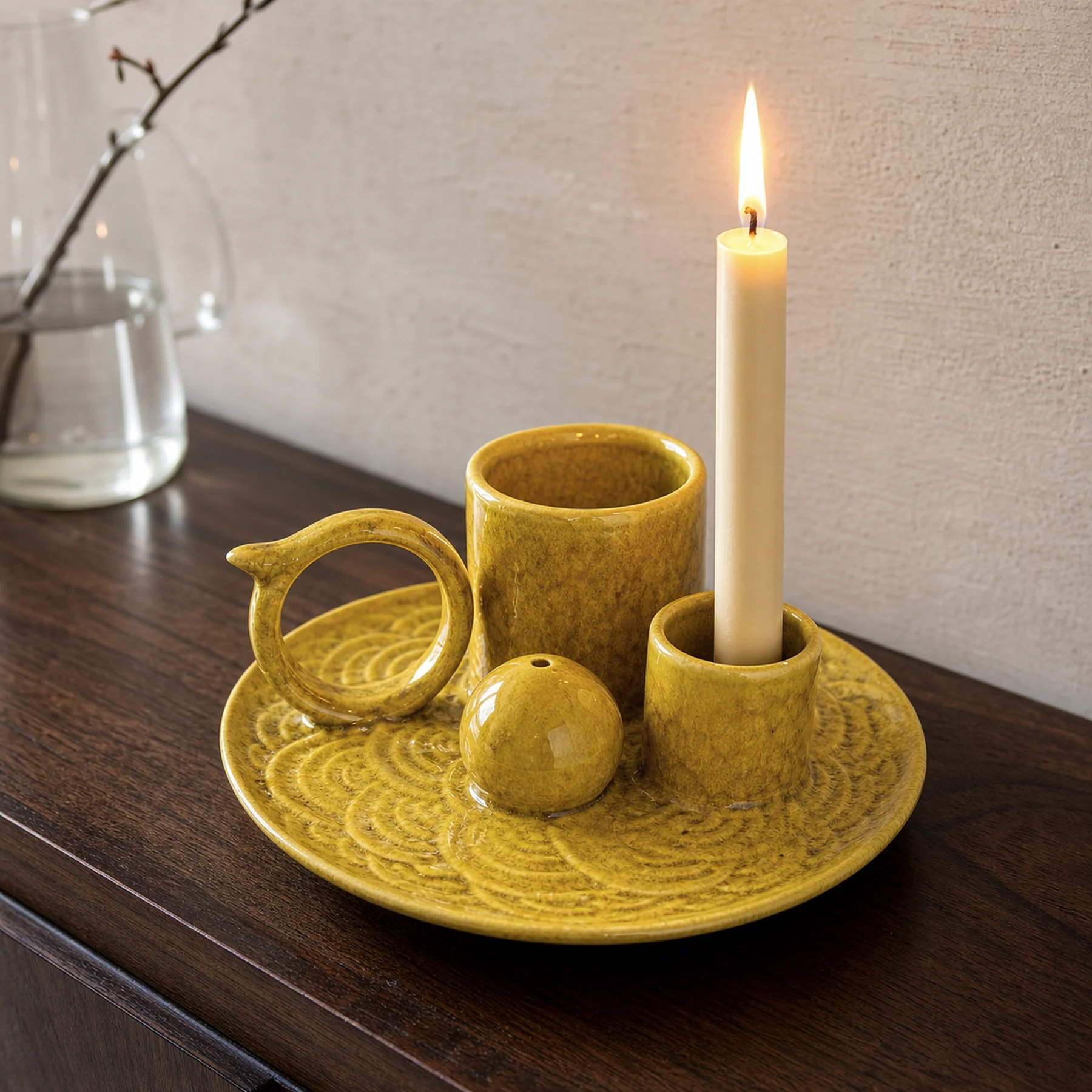 Yellow glaze 5-in-1 ceramic smudge bowl holding a lit taper candle with a natural flame