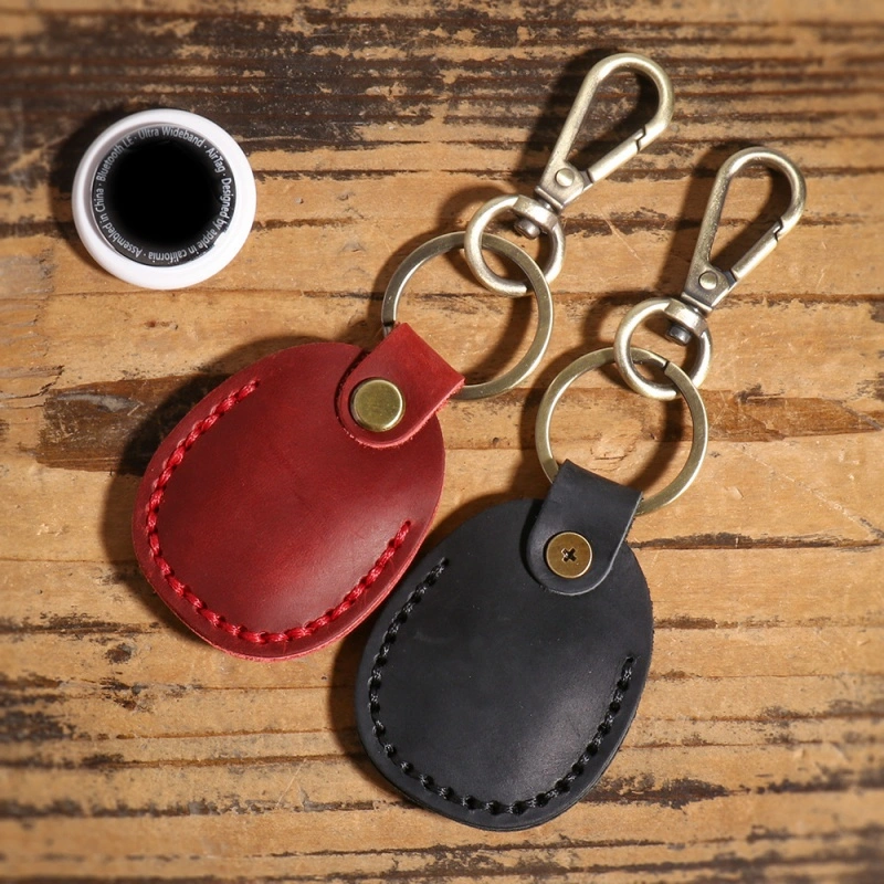 Leather AirTag keychain attached to keys and travel bag