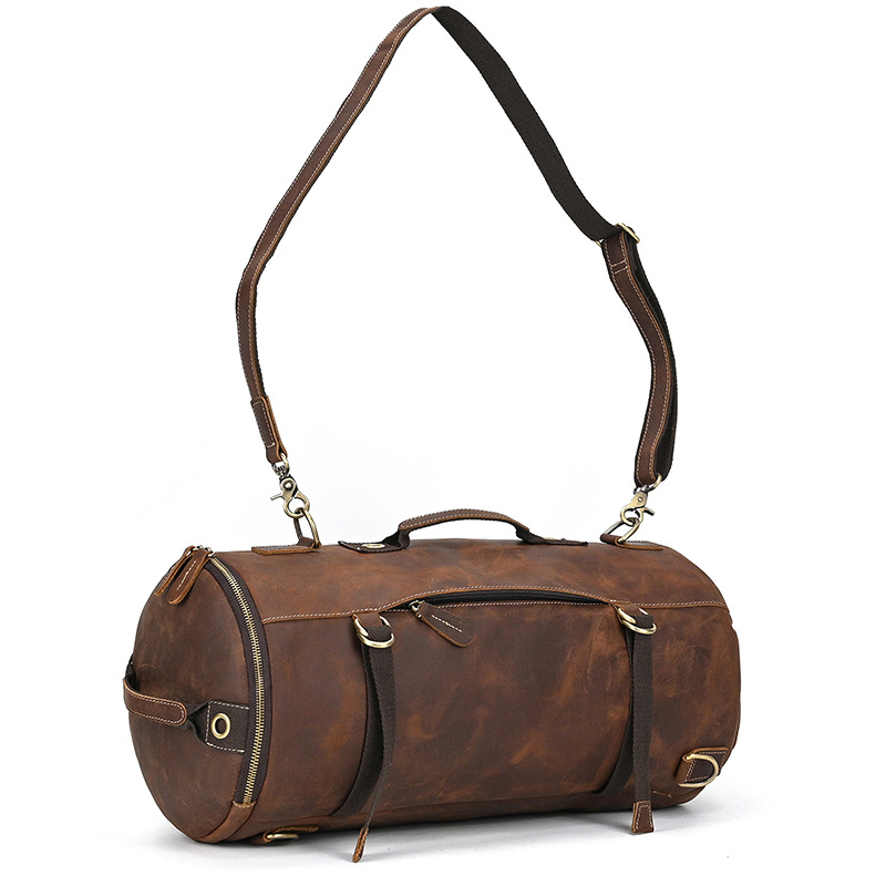 Round leather duffle bag with top zipper opening
