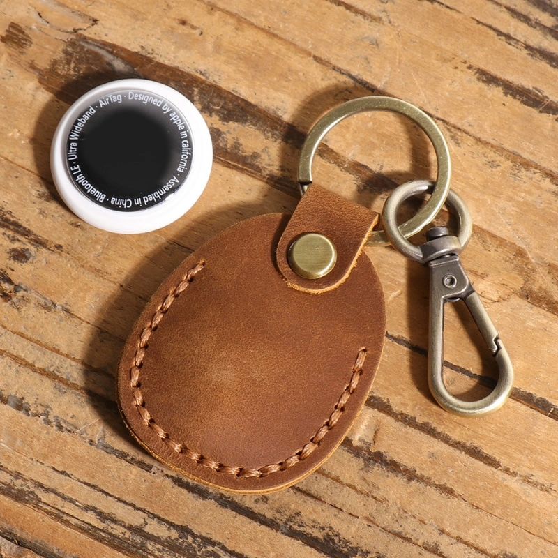 Apple AirTag placed inside leather keychain holder