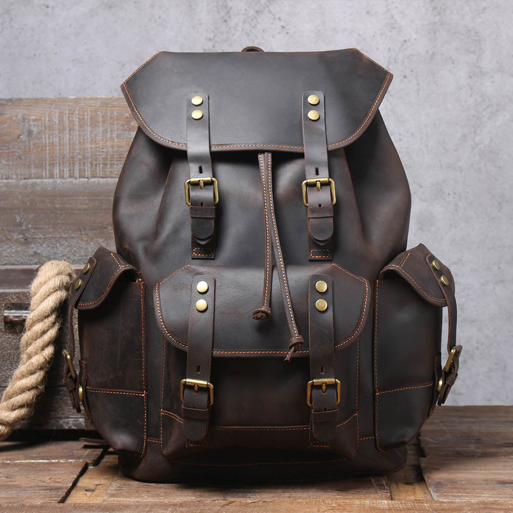 sleek cognac real leather carry on knapsack with sturdy stitching and webbing and zipped pockets to carry a wallet, coin purse, card holder or sunglasses